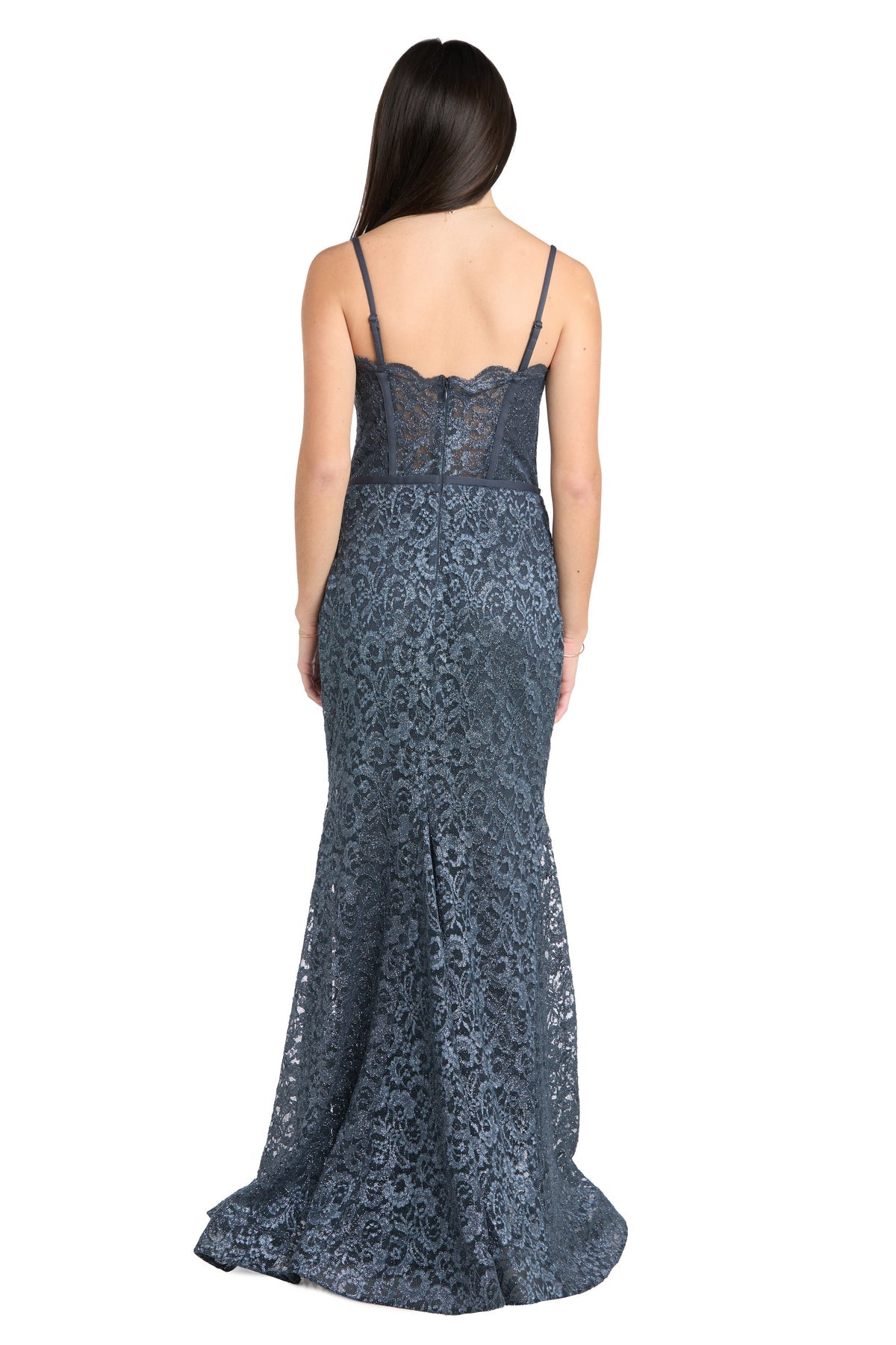 A woman with long dark hair wears the strapless Morgan 13269 long lace prom dress and stands facing away from the camera against a white background.