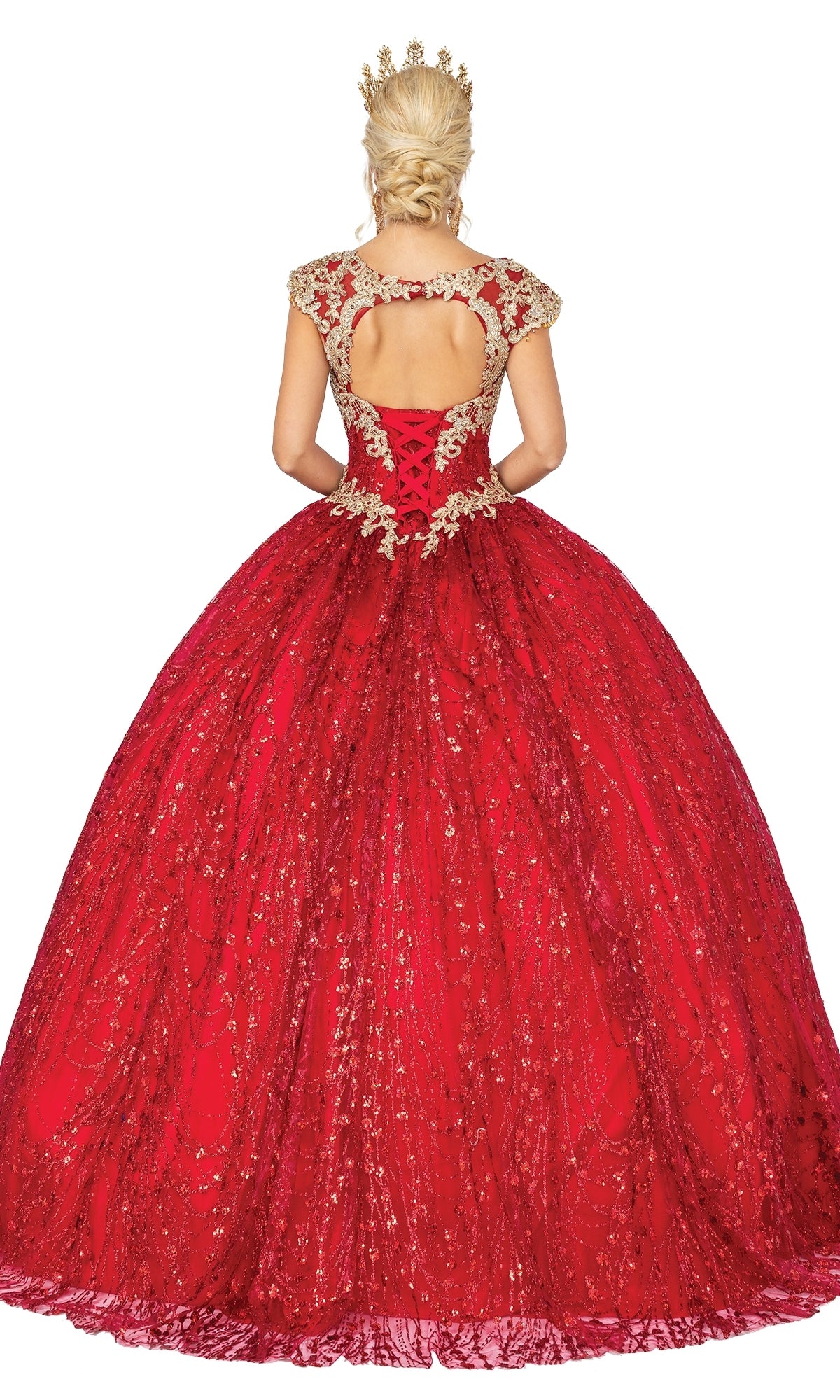 A woman with blonde hair in an updo wears the Quinceanera Dress 1397 by Dancing Queen, a red a-line ball gown with gold detailing and cap sleeves, crowned in gold and facing away from the camera.