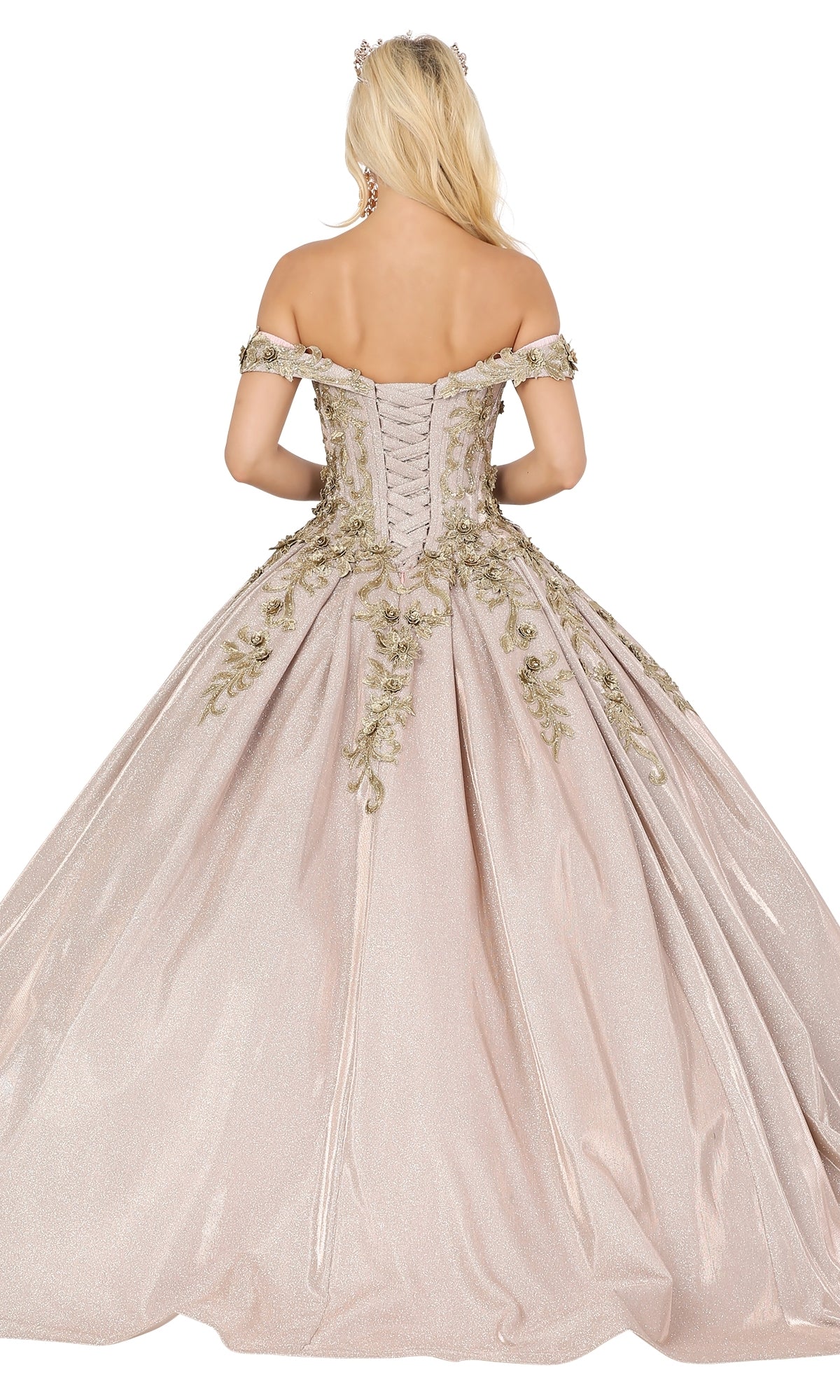 A woman stands elegantly with her back to the camera in the Quinceanera Dress 1504 by Dancing Queen, an off-the-shoulder A-line ball gown featuring a gold lace embroidered bodice and lace-up back.
