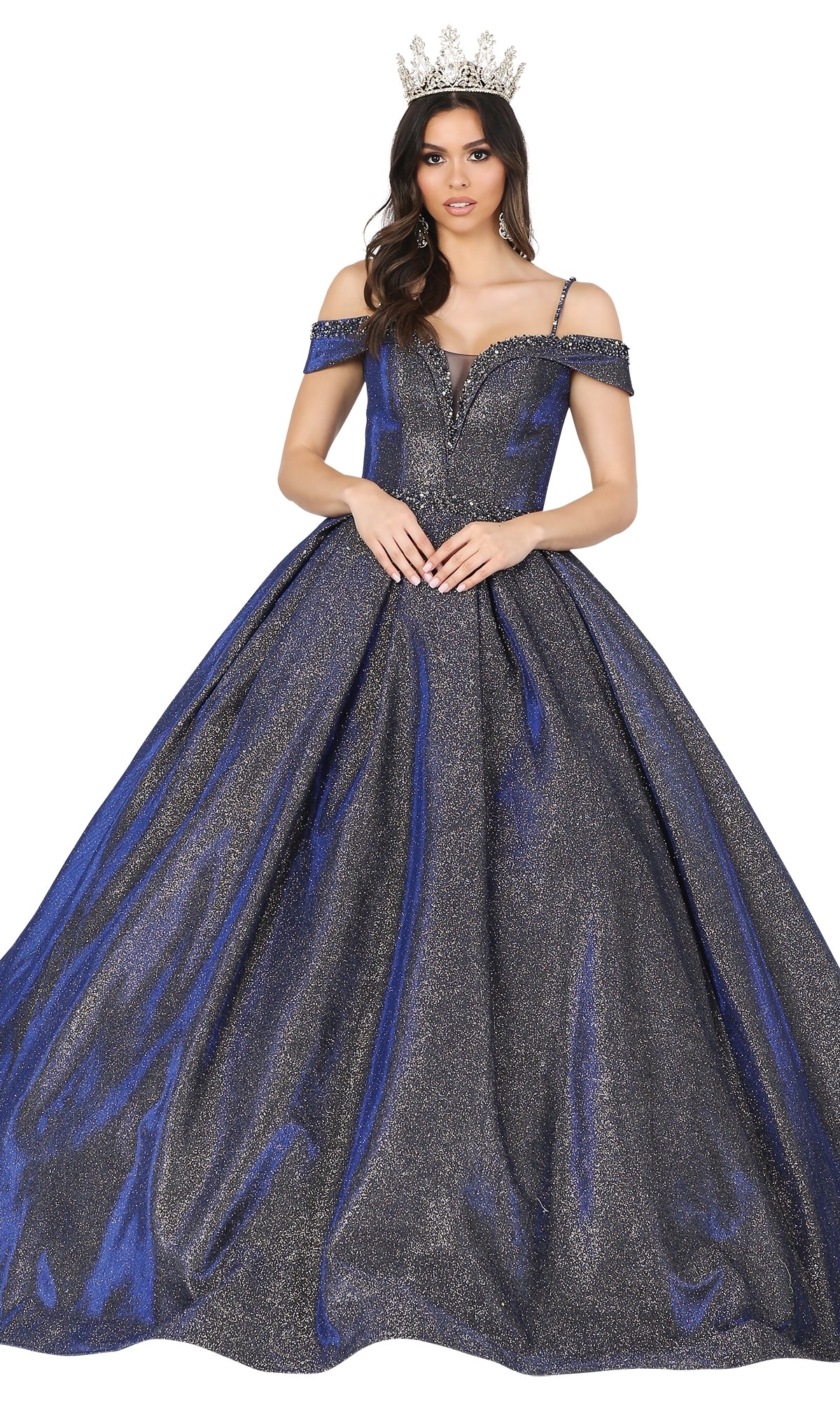 A woman in a crown wears the Quinceanera Dress 1506 by Dancing Queen, an off-the-shoulder blue and silver A-line ball gown with a full skirt, standing against a white background.