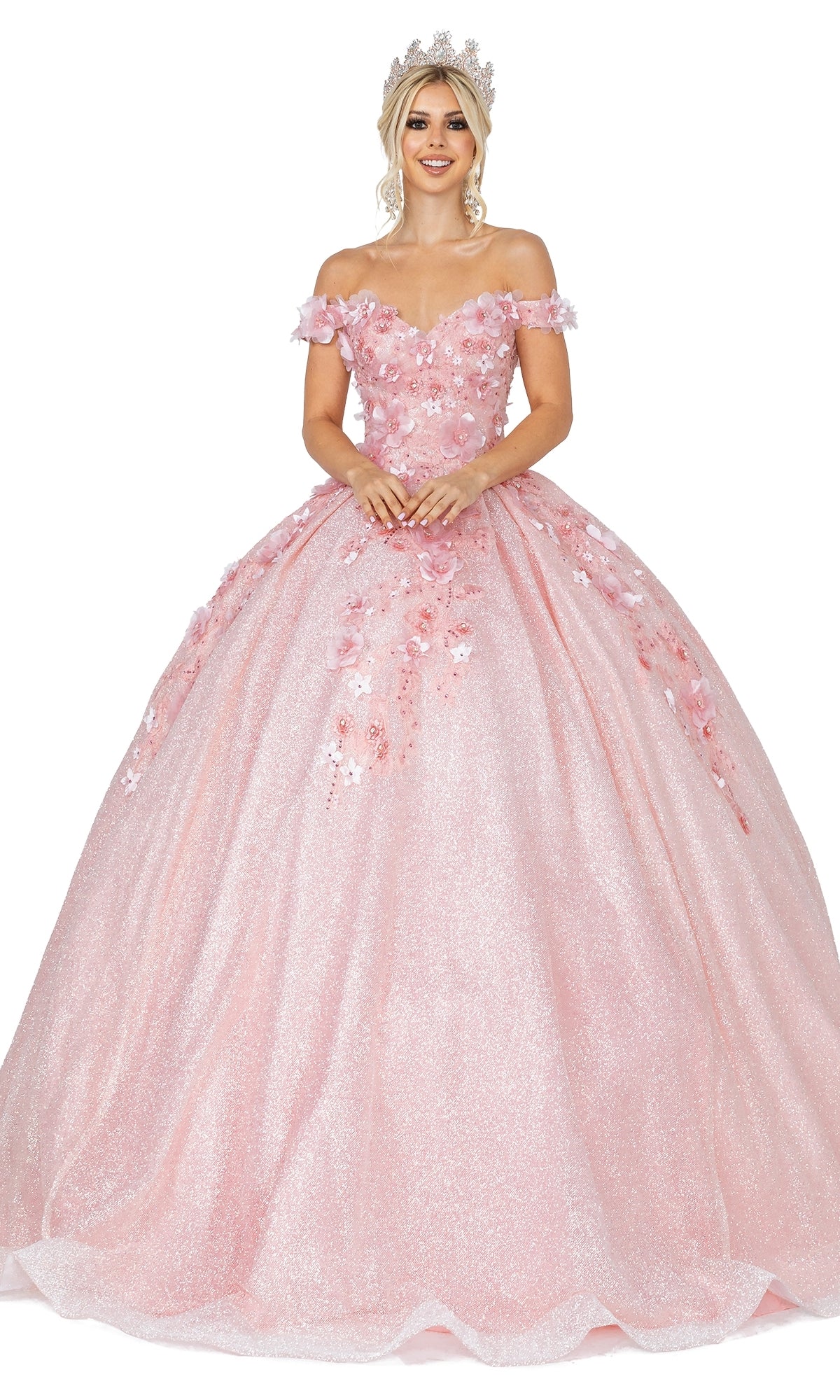 A woman smiles in the elegant Quinceanera Dress 1527 by Dancing Queen—a sparkling pink off-the-shoulder ball gown with floral embellishments and a jeweled crown.