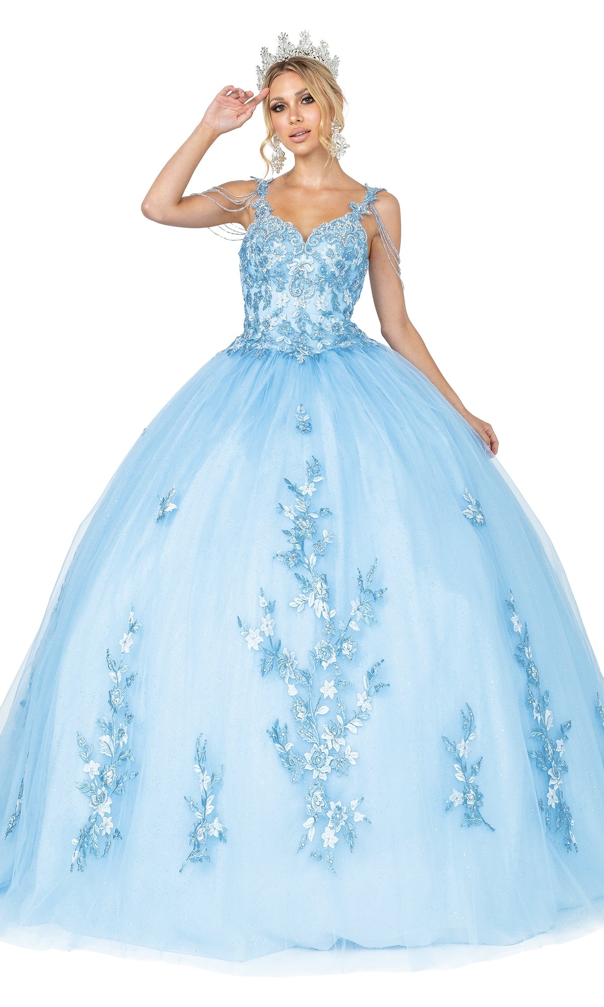 A woman in the Quinceanera Dress 1546 by Dancing Queen, featuring floral appliques, beaded draped shoulder, and a tiara, poses elegantly against a white background.