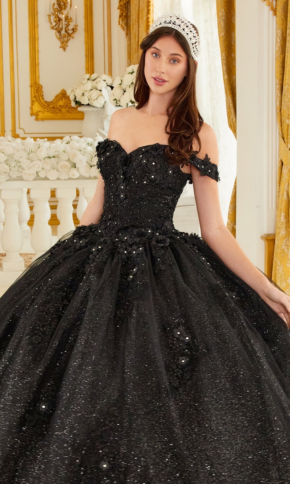 A woman in the Ladivine 15702 Quinceañera Dress with 3-D Flowers and a tiara stands in an ornate room featuring gold accents and white floral arrangements.
