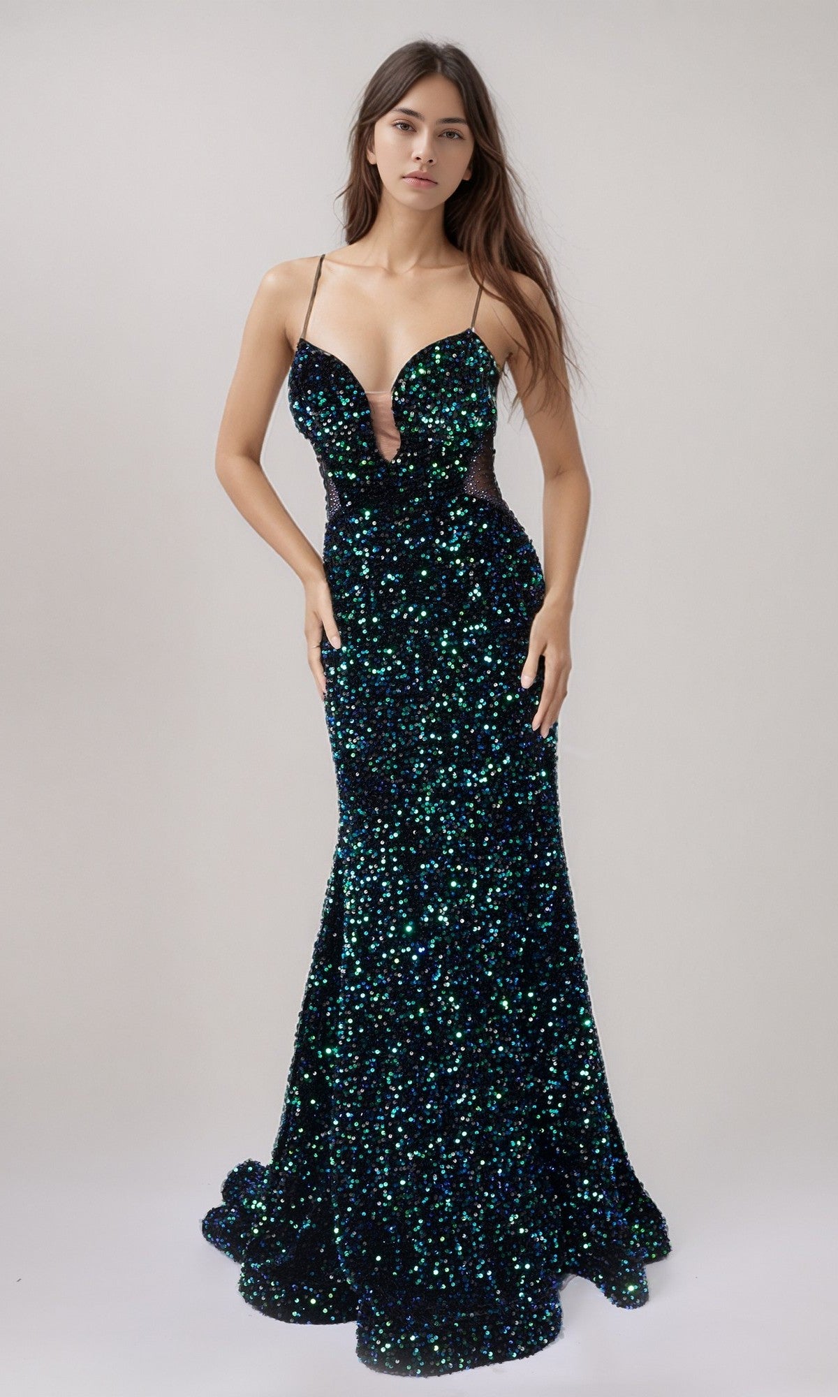A woman wears the Nina Canacci 1616 Long Formal Dress in Black/Multi with green and blue sequins, a deep neckline, thin straps, and an adjustable lace-up back, standing against a plain background.