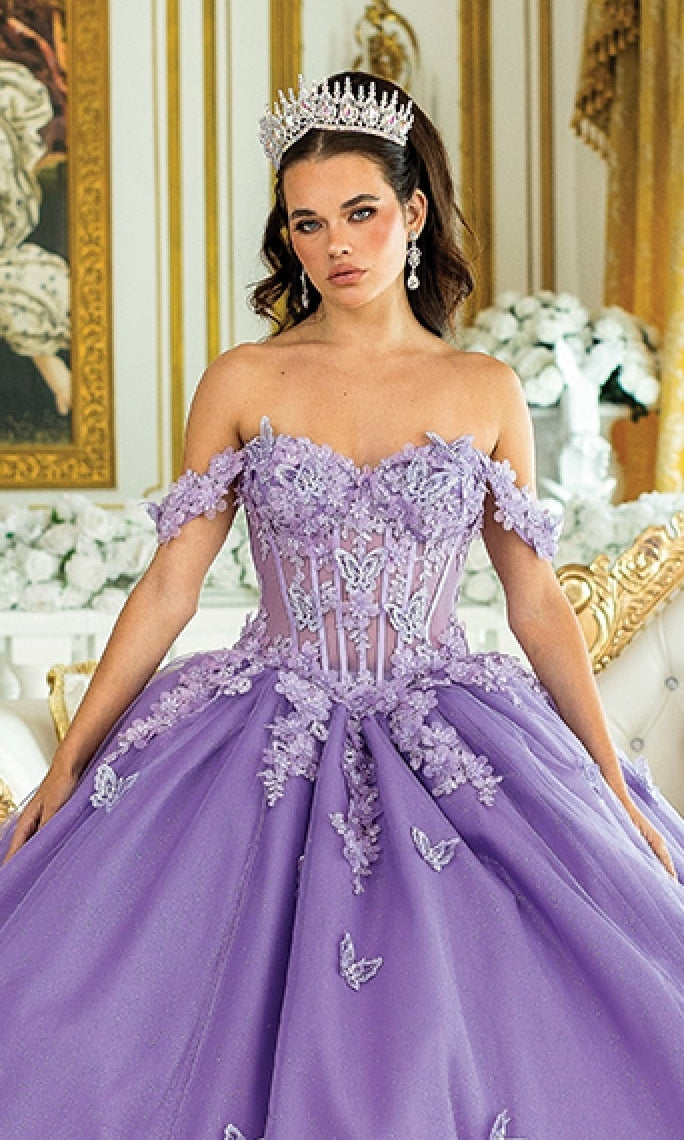 Woman in a purple ball gown with butterfly embellishments in an elegant room.