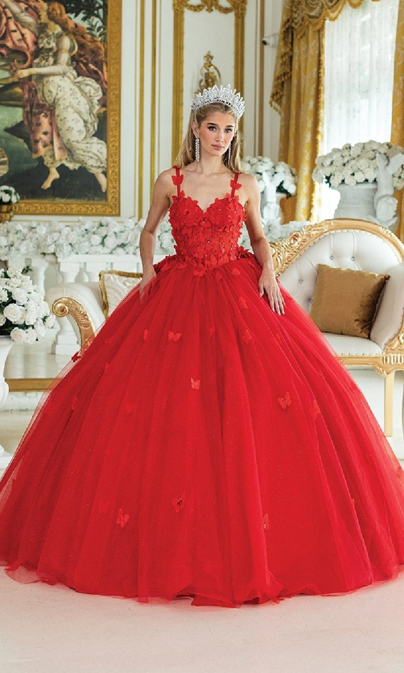 A woman in a luxurious red quinceañera a-line ball gown with sweetheart neckline and bow detail on the back, standing in an elegant room.