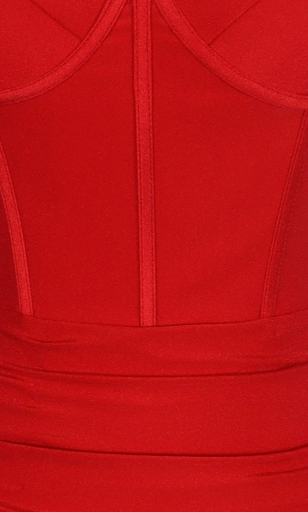 Close-up of the Tight Mini Hoco Dress: PromGirl Exclusive 250163, a red garment with vertical seams and structured panels, evoking a corset-style bodice perfect for homecoming.