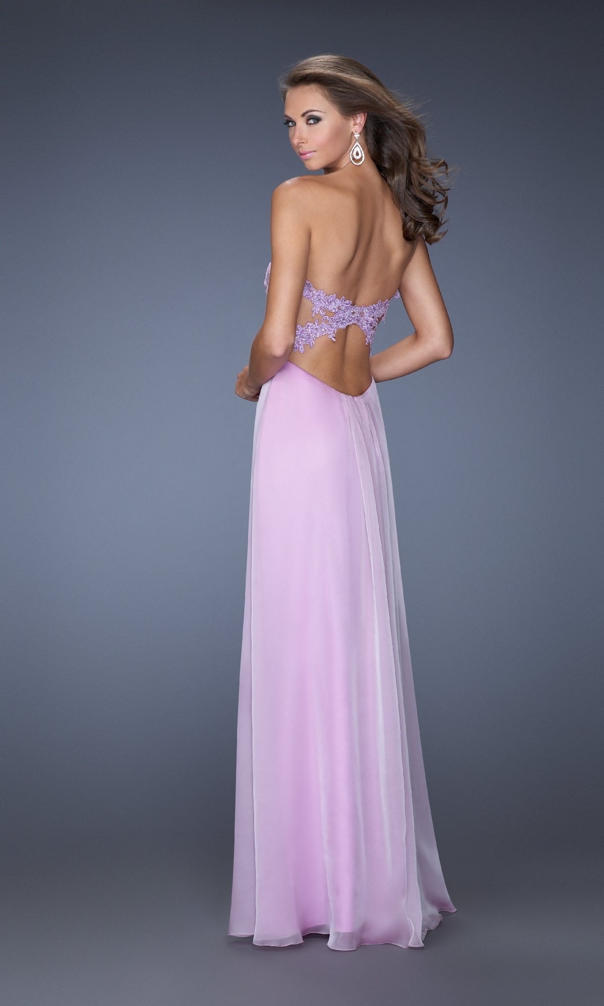 Woman wearing the Strapless Long A-Line Prom Dress: La Femme 20042 in light purple with lace detailing, sweetheart neckline, and open back, standing against a plain gray background.