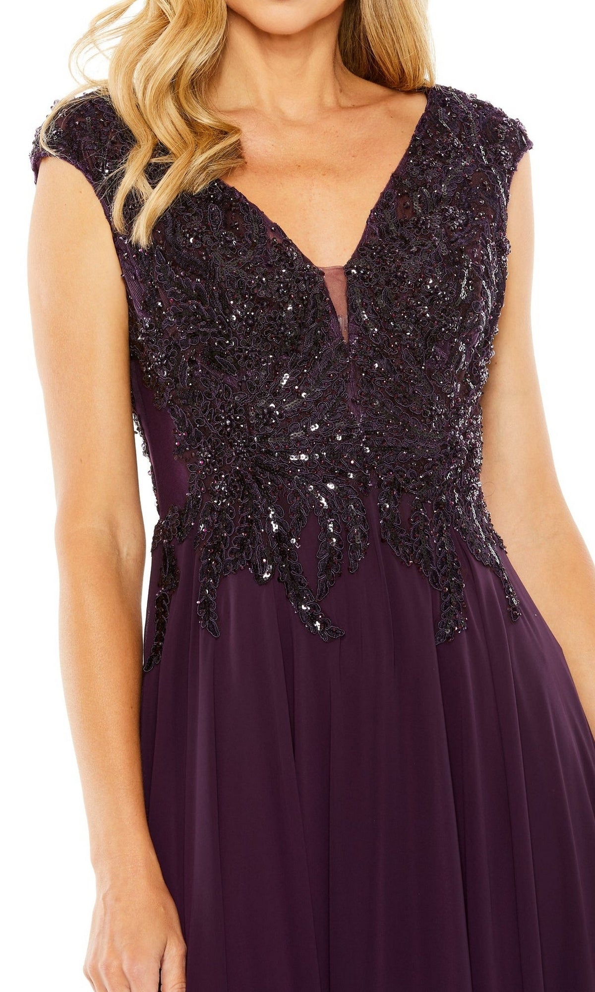 A woman in the Mac Duggal 20264 Beaded-Bodice Long Formal Dress, featuring a sleeveless deep purple A-line silhouette and an intricately beaded v-neck bodice.