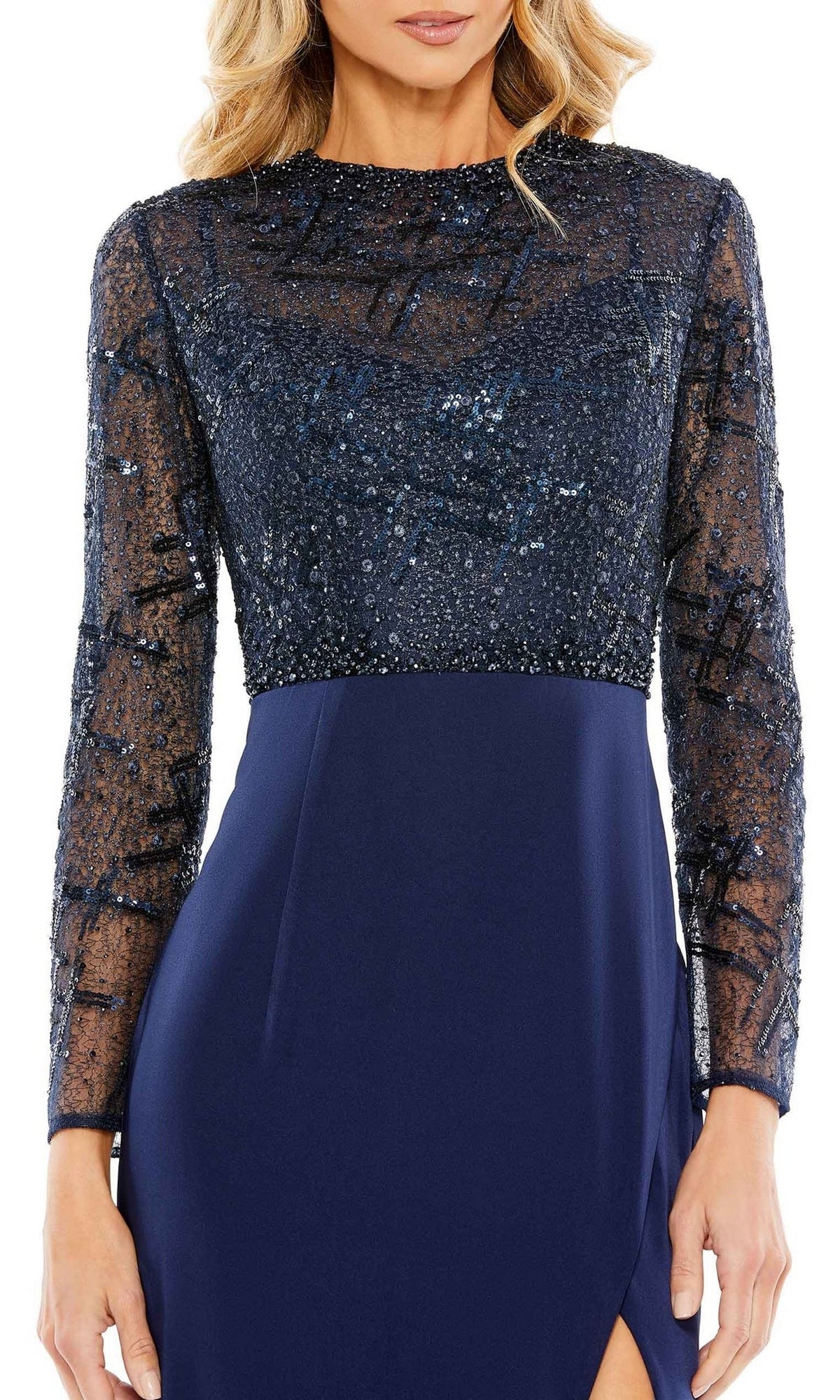 Woman wearing the Long Sleeve Blue Formal Dress: Mac Duggal 20340, a blue gown with sequined sheer overlay on the bodice and sleeves, and a high neckline for an elegant formal look.