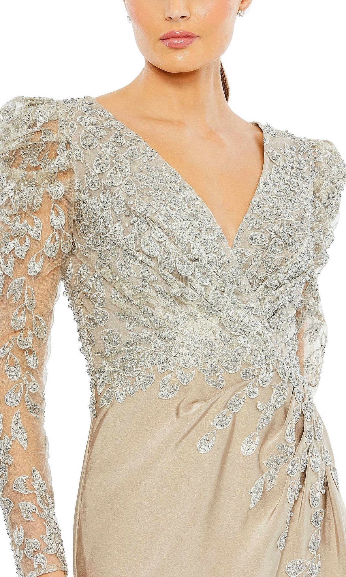 Woman wearing the Long Formal Dress 20346 by Mac Duggal, a light beige v-neck dress with puff sheer sleeves and ornate silver leaf embroidery, shown from shoulders to hips.