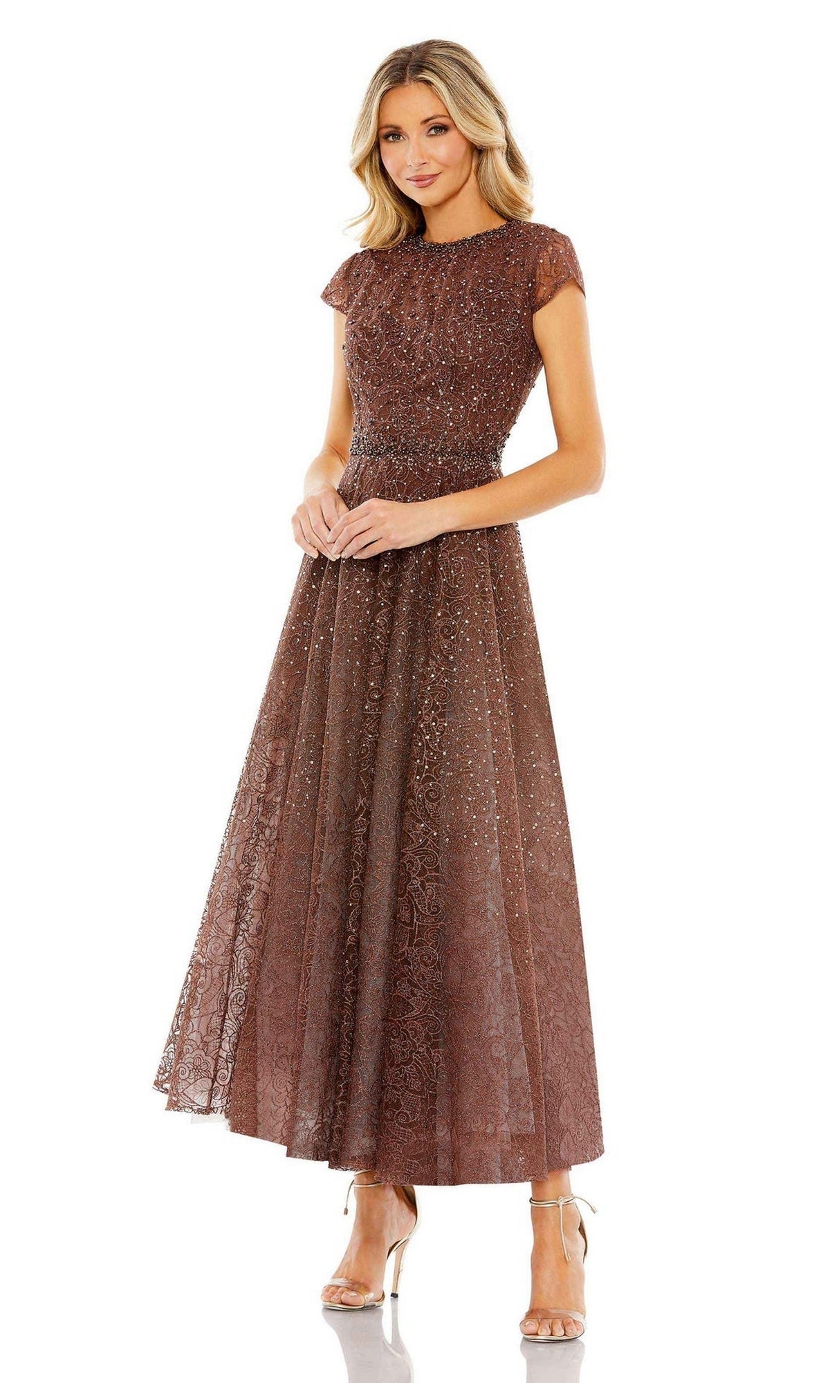 A woman wears the Cap Sleeve A-Line Formal Dress: Mac Duggal 20371 in brown, featuring a fitted waist, ankle-length hem, cap sleeves, subtle glitter detail, and nude high-heeled sandals.