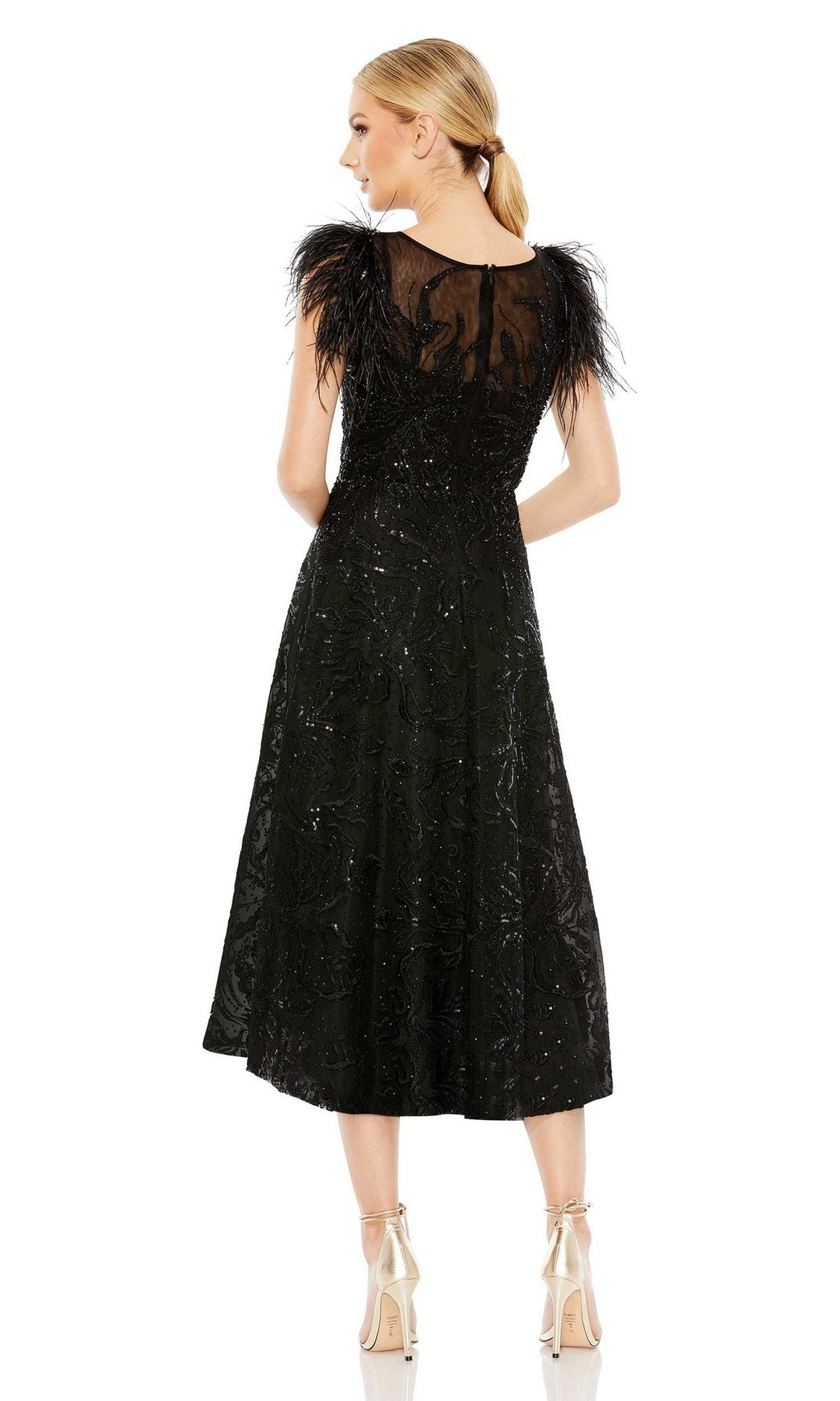 A woman faces away, wearing the Mac Duggal 20400 black sequin wedding guest dress with feathered sleeves and sequin accents, paired with beige high heels.