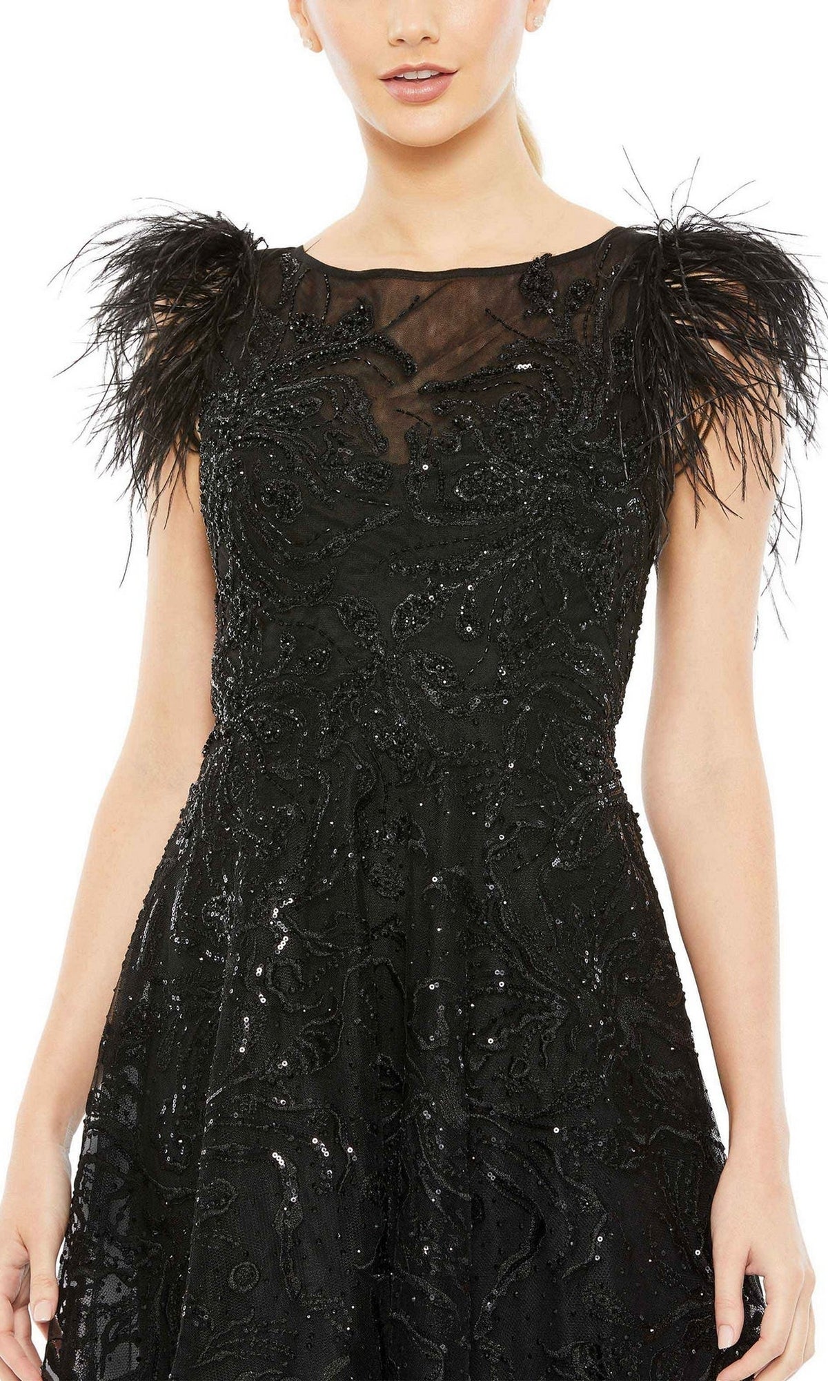 A woman wears the Mac Duggal 20400 Black Sequin Wedding Guest Dress, featuring a sheer neckline and feathered shoulder details.