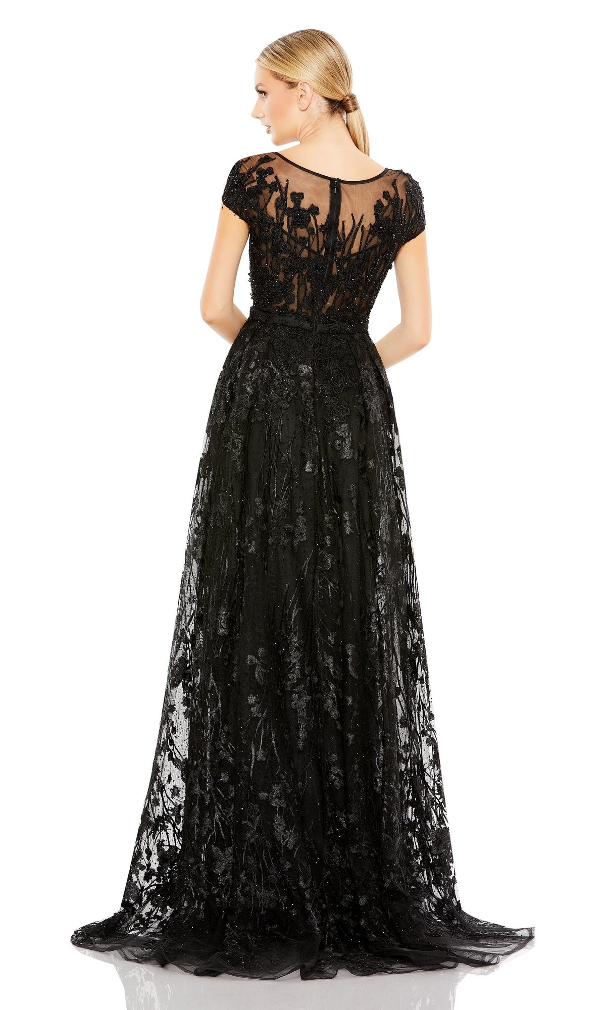 A woman is shown from the back in a Mac Duggal 20405 Short-Sleeve Long Formal Dress, featuring embroidered lace and floral details, set against a white background.