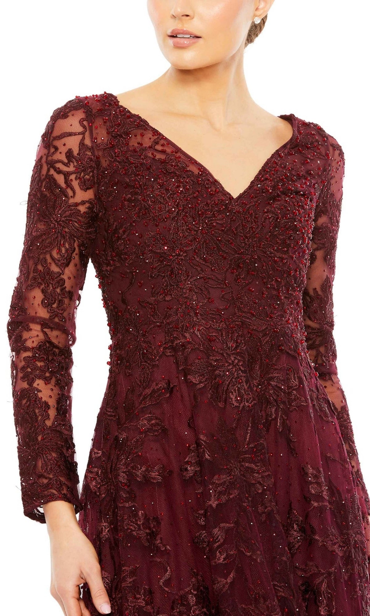 A woman wears the Mac Duggal 20409 long formal dress, featuring dark red lace, intricate floral embroidery, and bead detailing, shown from shoulders to mid-thigh.