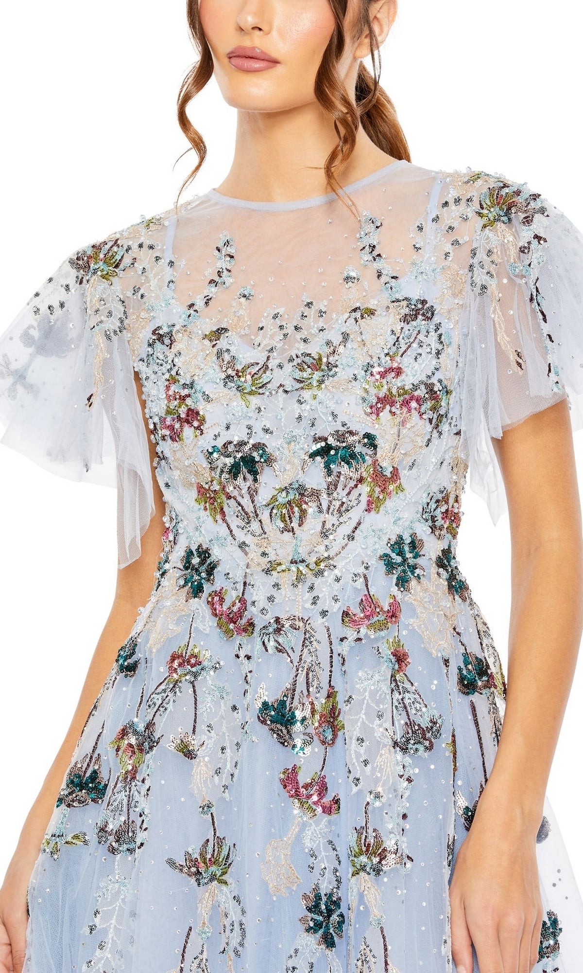 A woman wearing the Long Formal Dress 20436 by Mac Duggal, featuring a light blue hue, sheer flutter sleeves, and multicolored floral embroidery.