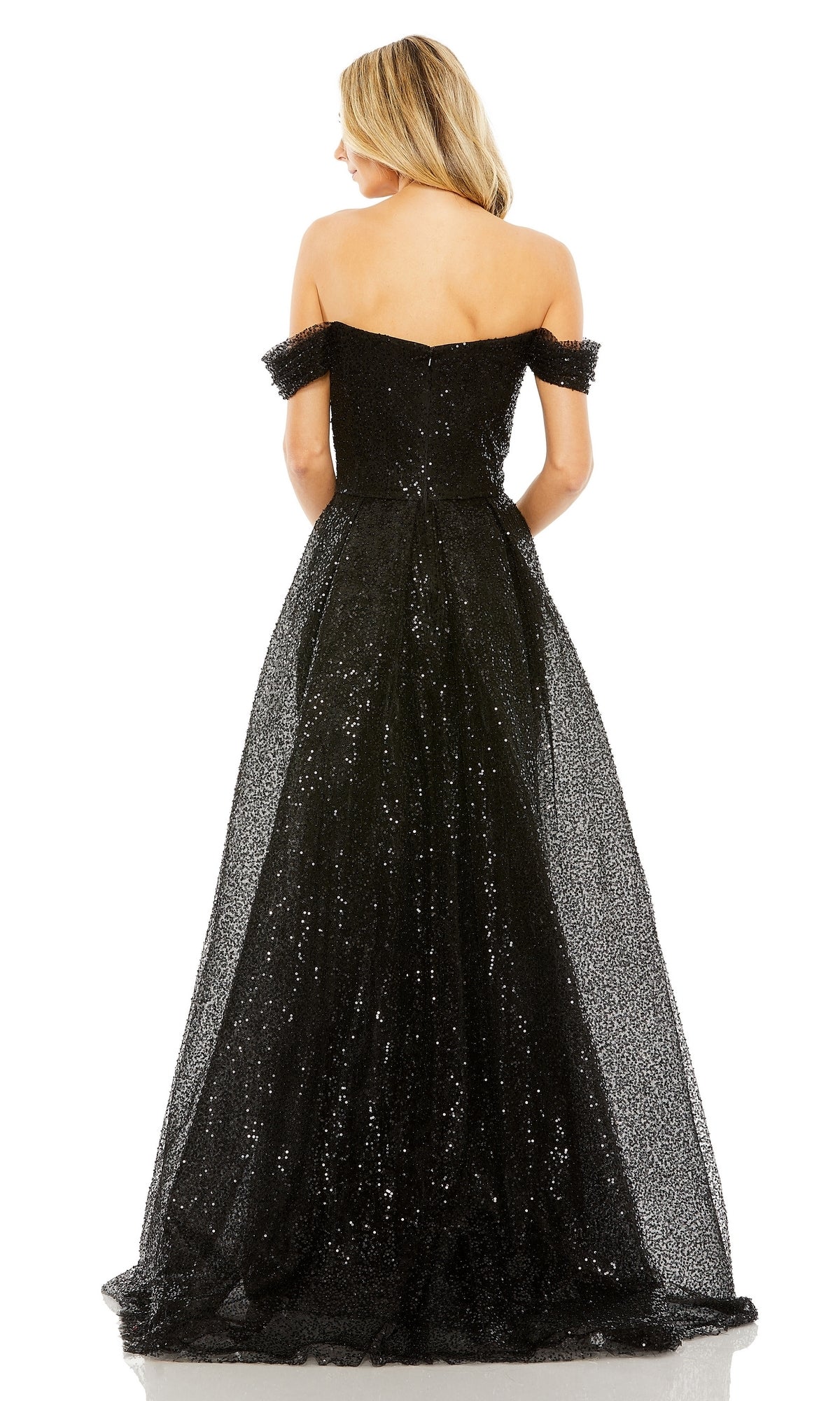 A woman stands facing away, wearing the Off-Shoulder Long Formal Dress: Mac Duggal 20515, featuring a sequin finish and full skirt with her hair down—a stunning choice for any elegant evening event.
