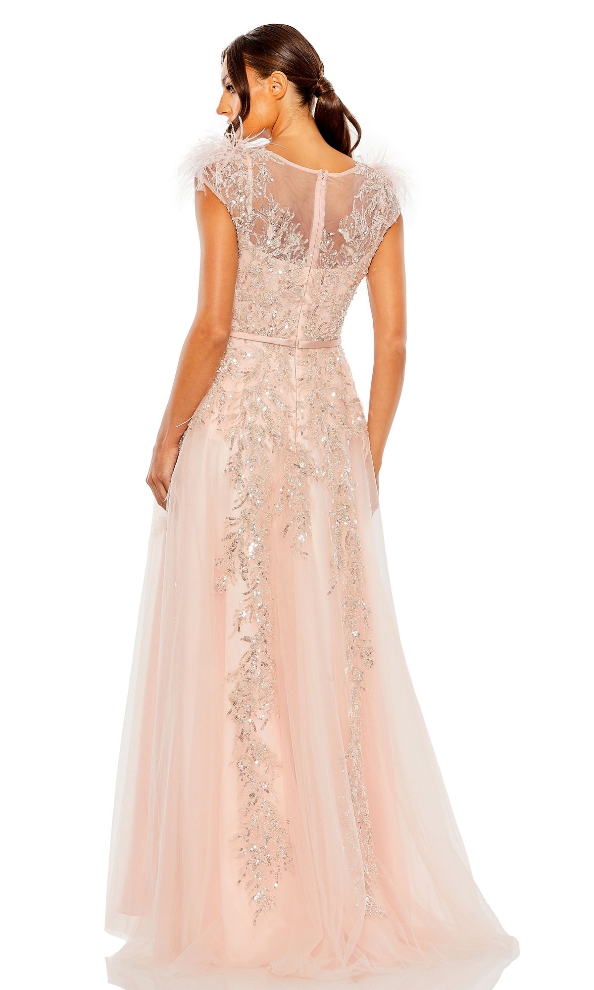 A woman is shown from the back wearing the Long Formal Dress 20520 by Mac Duggal, a pastel A-line gown with a sheer V-neckline, floor-length light pink skirt, sheer cap sleeves, floral embroidery, and sequin embellishments.