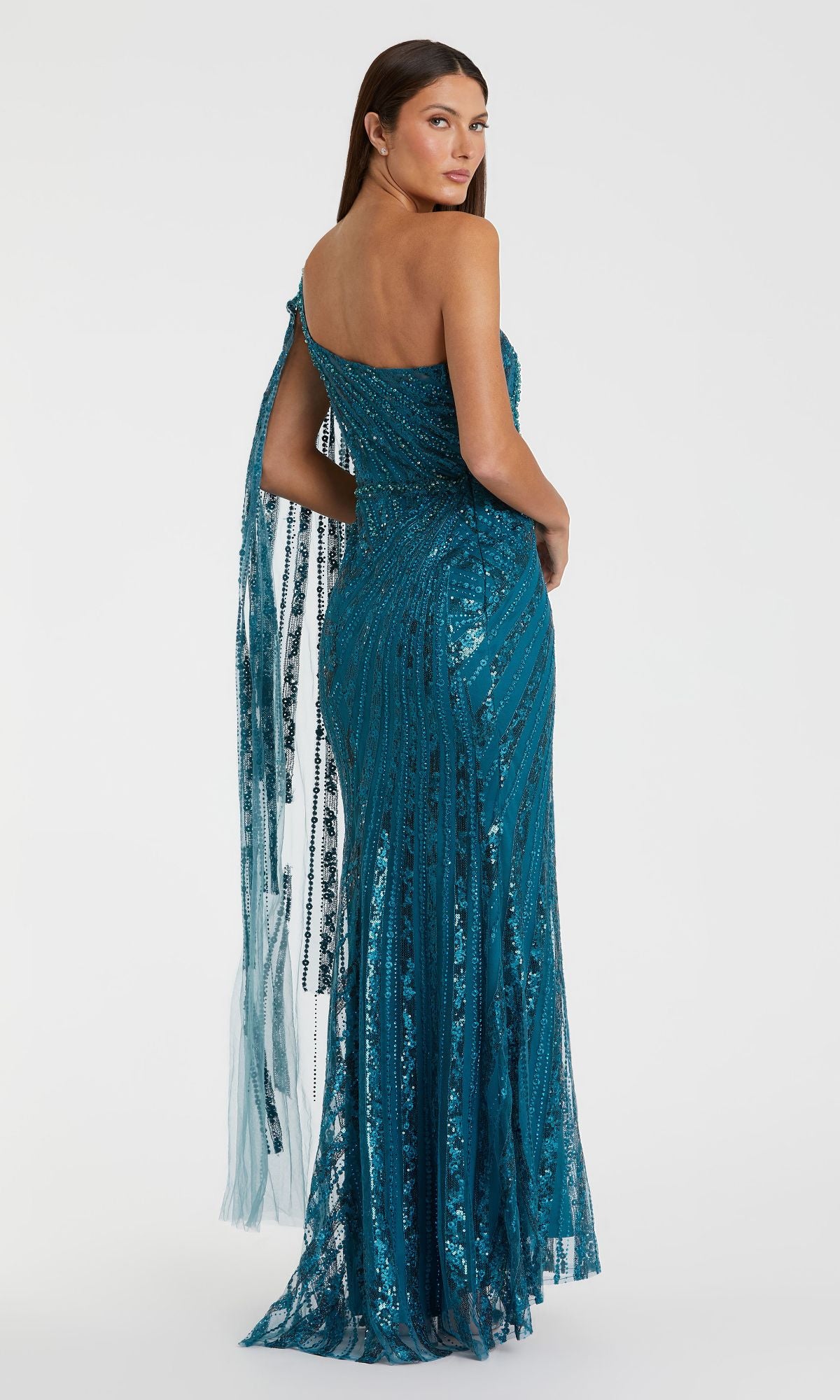A woman models the Mac Duggal 20528 One-Shoulder Long Prom Gown in teal sequin, featuring sheer lace and draped tulle accents, standing against a plain white background.