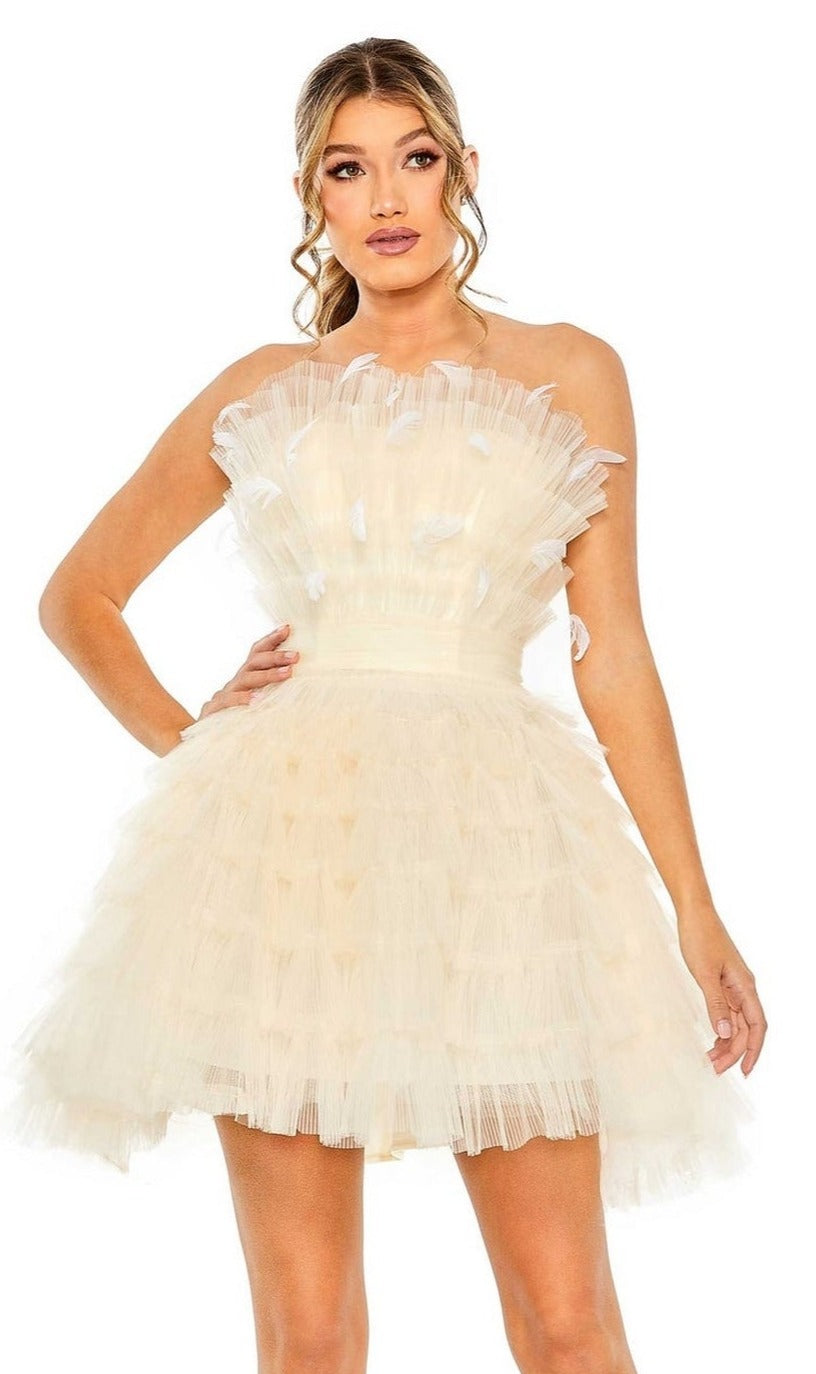 A woman poses with one hand on her hip, wearing the Strapless Ruffle Party Dress: Mac Duggal 20529 in cream, against a plain white background.