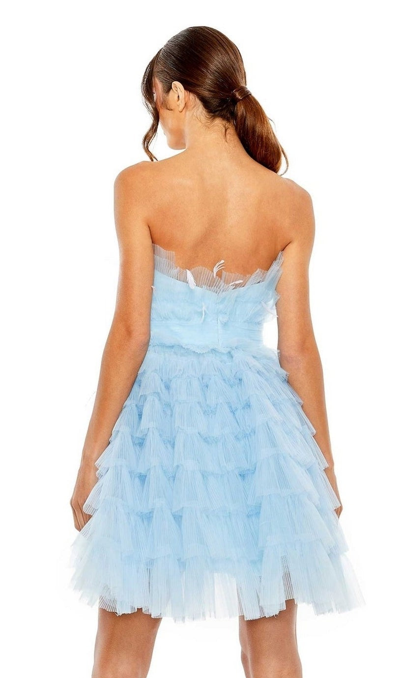 A woman with her hair in a low ponytail wears the Mac Duggal 20529 Strapless Ruffle Party Dress in light blue, shown from the back.