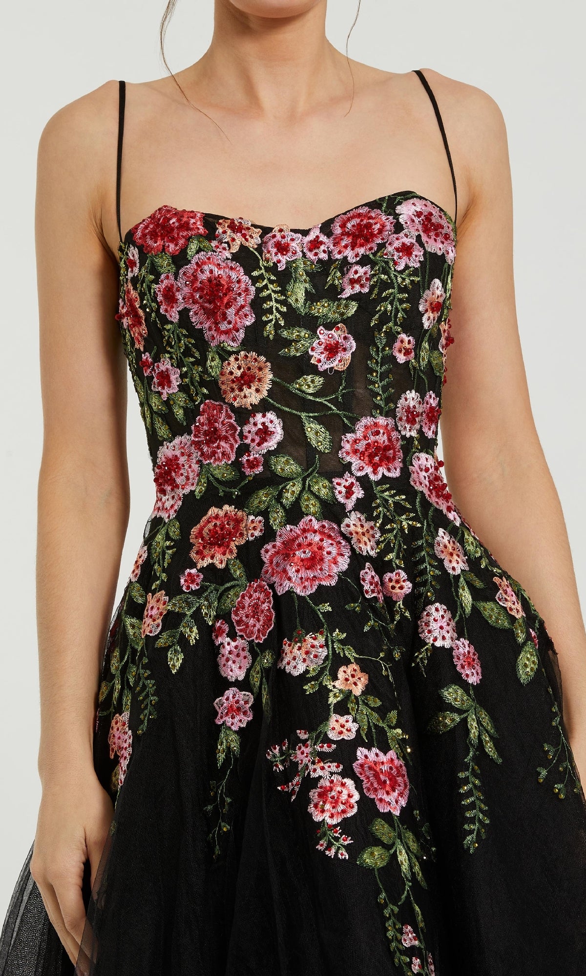 Woman in the Mac Duggal 20651 Floral Embroidered A-Line Midi Dress—a sleeveless black dress with thin straps and red and pink floral embroidery, ideal as a party or wedding guest dress.