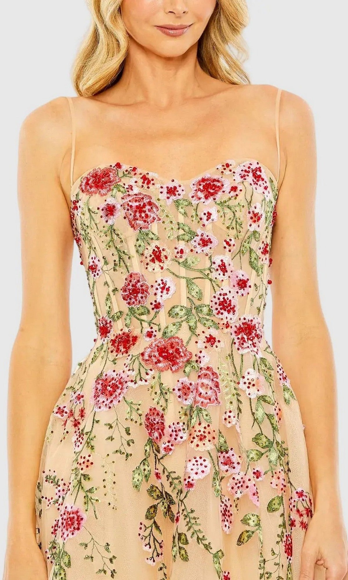 Woman in the Mac Duggal 20651 Floral Embroidered A-Line Midi Dress—sleeveless, nude-toned with thin straps and red floral embroidery—ideal as a wedding guest dress.