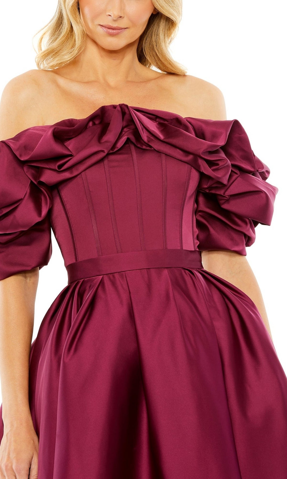 A woman wearing the Mac Duggal 20706 Off-Shoulder Wedding Guest Dress in burgundy satin, with ruched puff sleeves and a fitted bodice—an elegant, semi-formal midi dress choice.