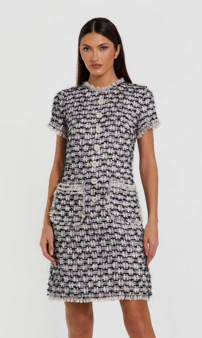 Woman wearing a patterned dress on a white background