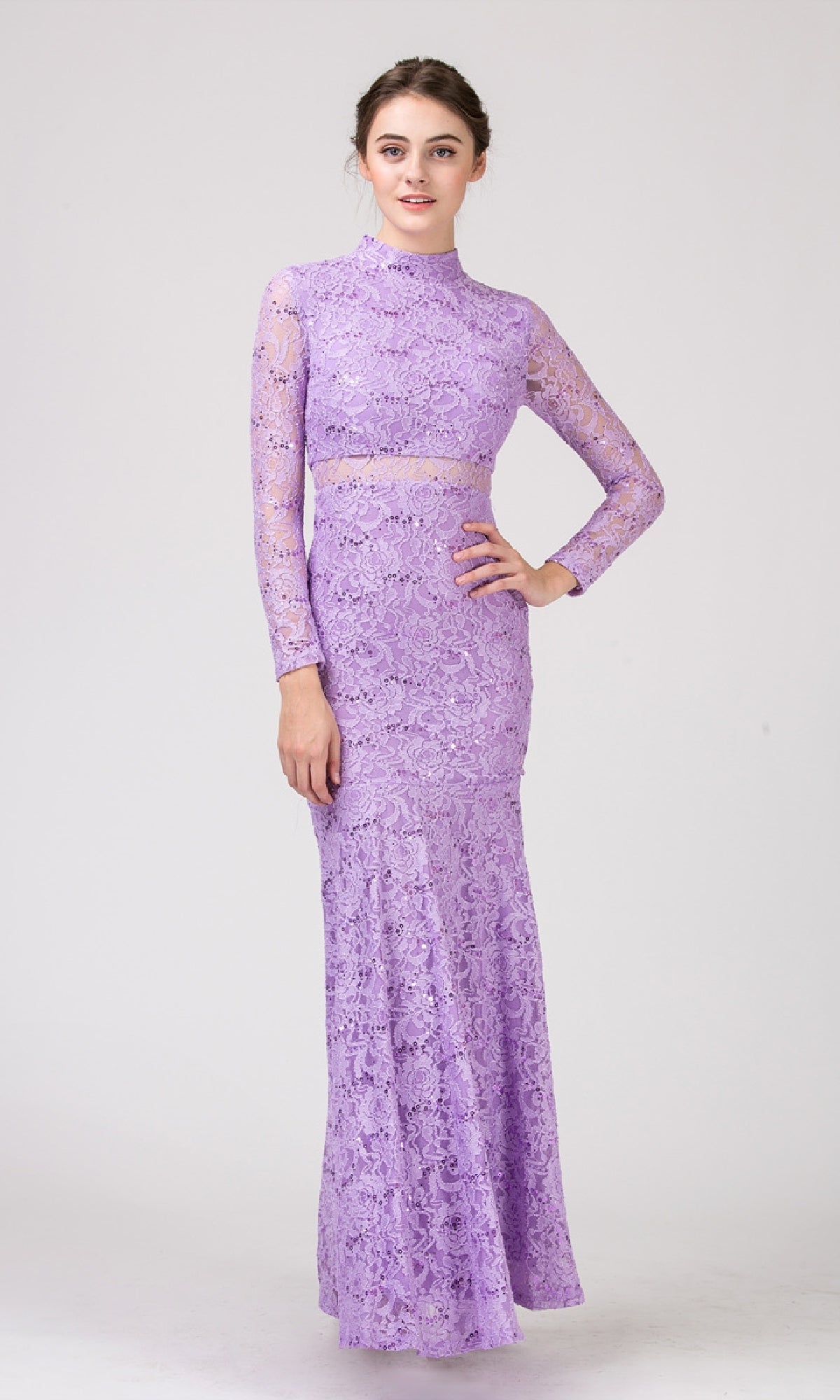 A woman wears the Eureka 2095, a long-sleeve, floor-length lavender sequin-lace formal dress featuring a high neckline and sheer lace details.