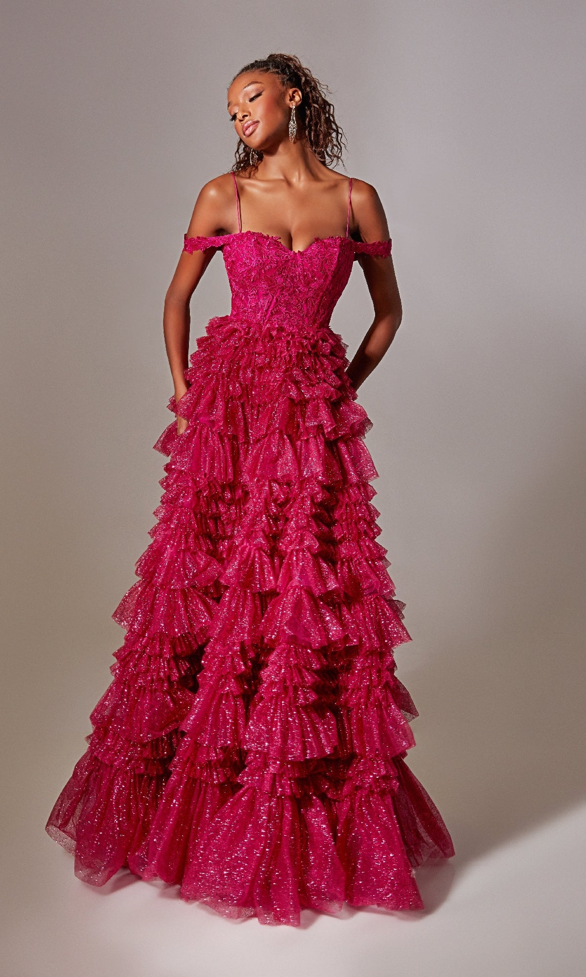 A woman wearing the Raspberry Pink Long Glitter Prom Dress with ruffles stands against a plain background.