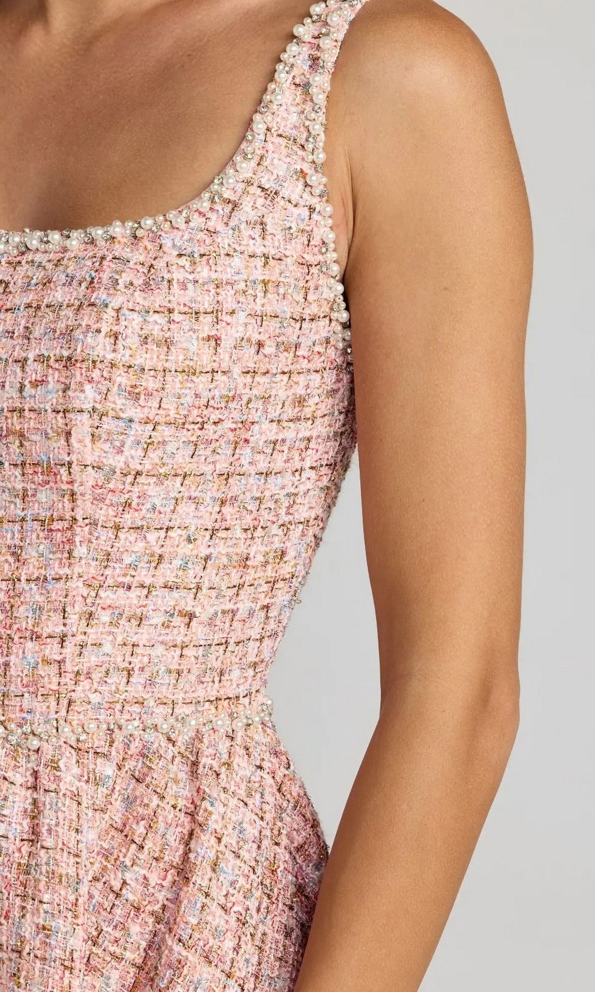 Close-up of the Midi Party Dress: Mac Duggal 21207, featuring pink tweed fabric with a scoop neckline and pearl embellishments along the edge, worn by a model against a plain gray background—offering a refined and elegant look.
