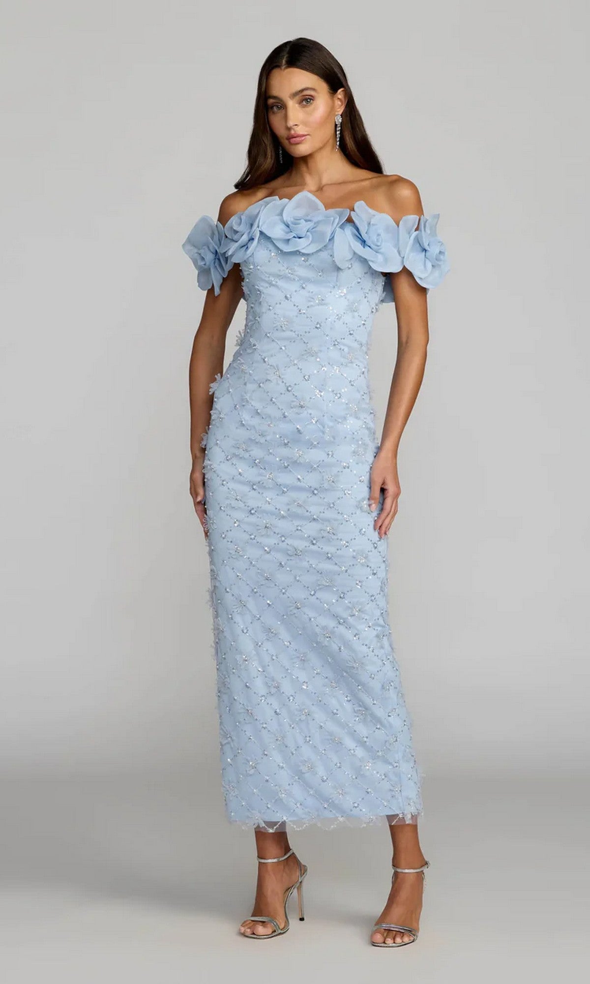 A woman stands against a plain background wearing the Mac Duggal 21363 Midi Party Dress in powder blue, featuring an off-the-shoulder neckline, ankle-grazing length, delicate floral detailing, and a subtle sequin-lattice motif.