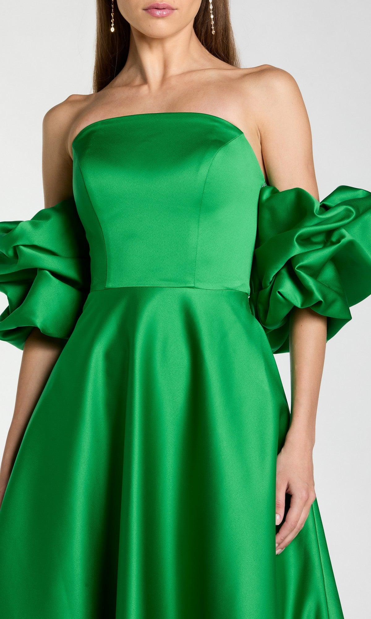 Woman wearing the Long Formal Dress: Mac Duggal 21375—a strapless, bright green satin ballgown with a fitted bodice and dramatic off-the-shoulder puff sleeves.