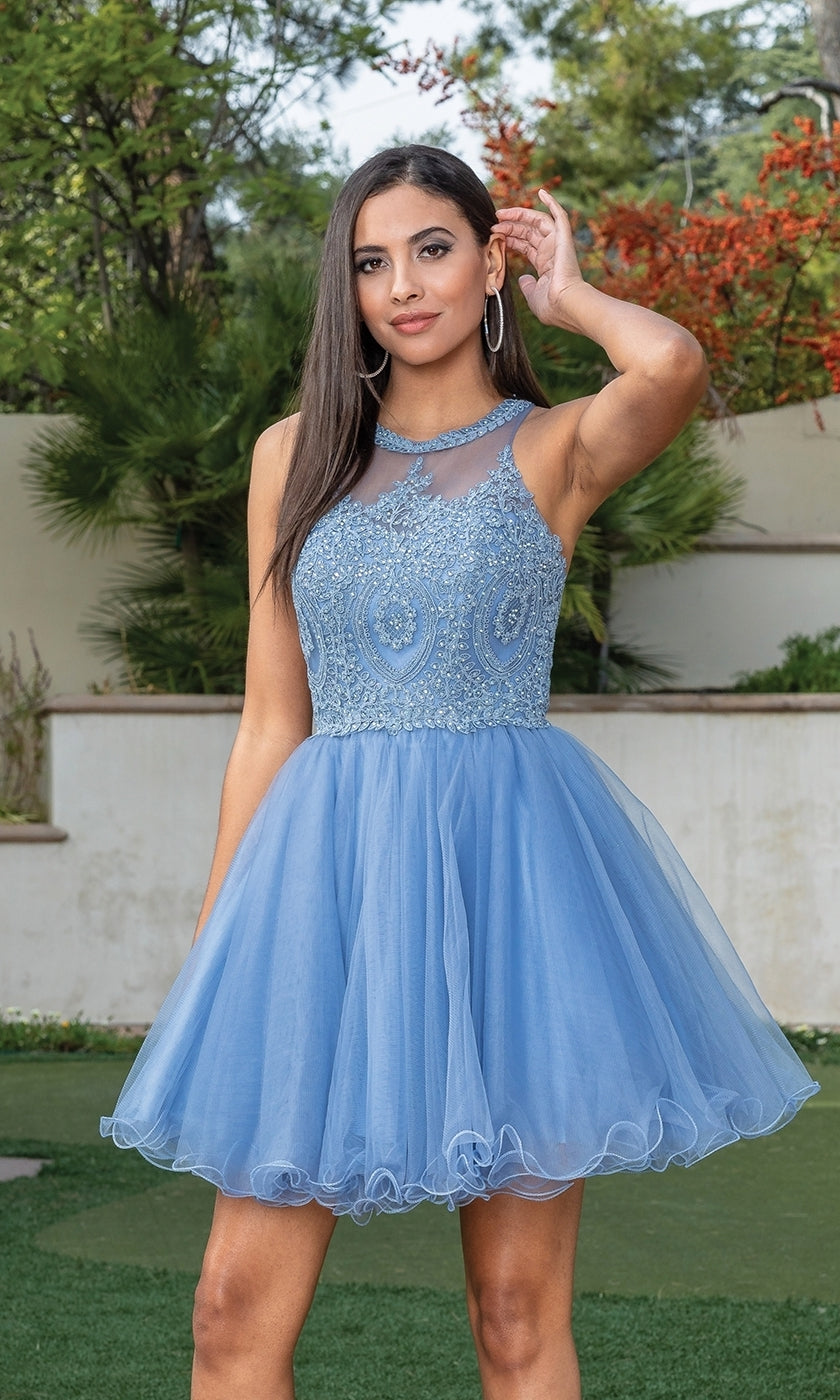 A woman stands outdoors in the Beaded Embroidered Lace Short Babydoll Party Dress, featuring a sleeveless light blue bodice with beading and a tulle skirt, touching her hair with one hand.