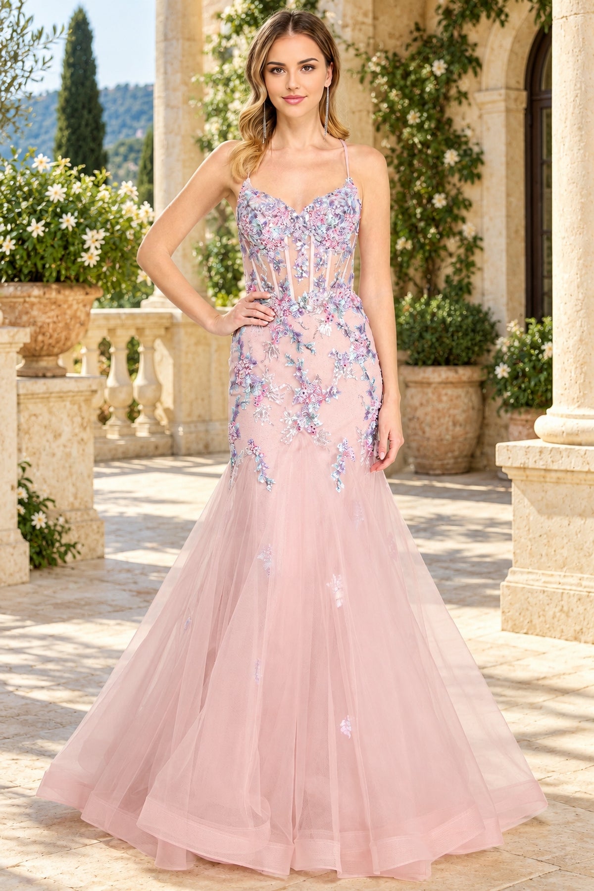 Amelia Couture 2164 floor-length, light pink mermaid prom dress with a corset-style bodice and blue and purple floral embroidery.