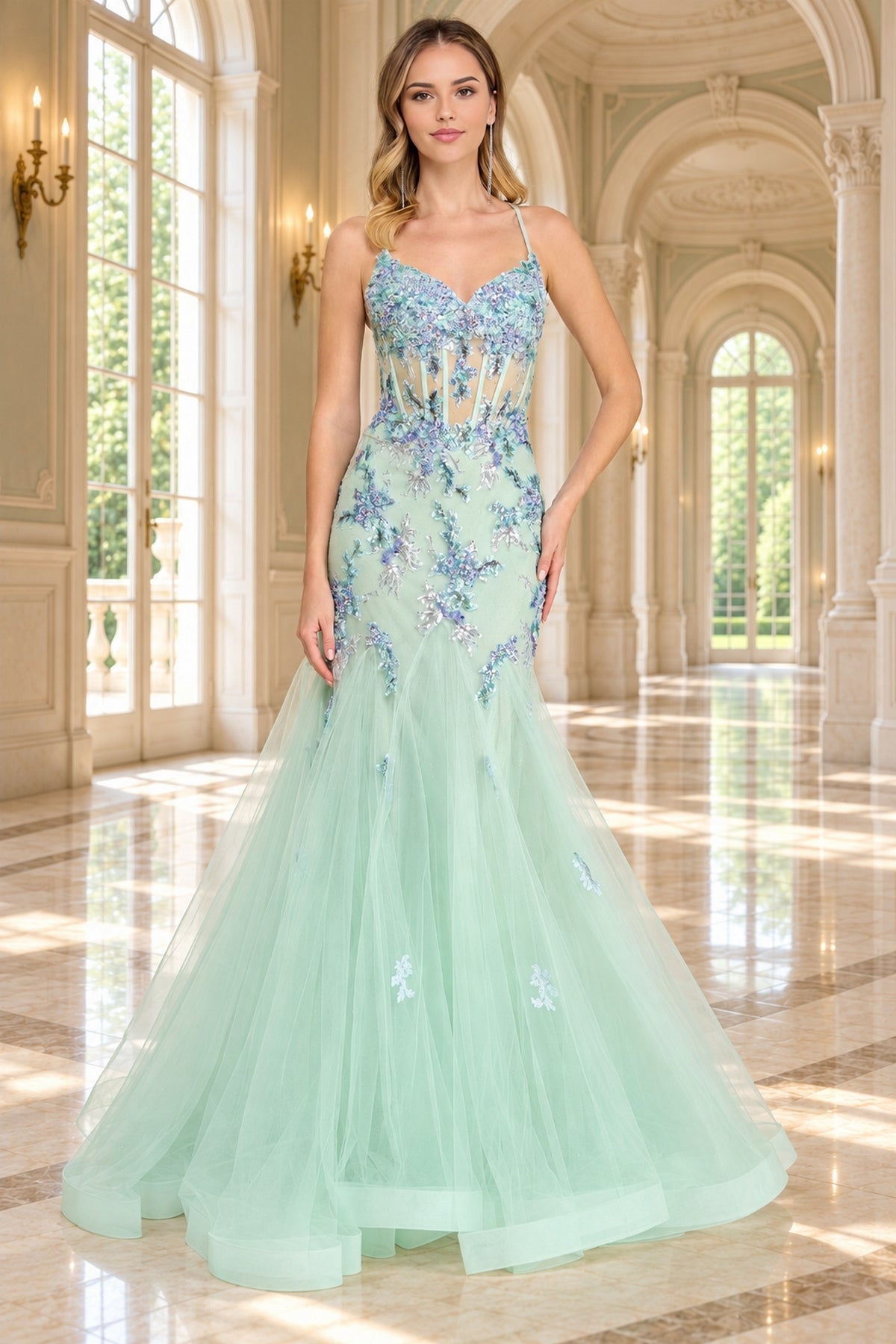 Amelia Couture 2164 mint green, floor-length mermaid prom dress with a sheer corset bodice featuring blue floral embroidery, beading, and sequin flower appliques.