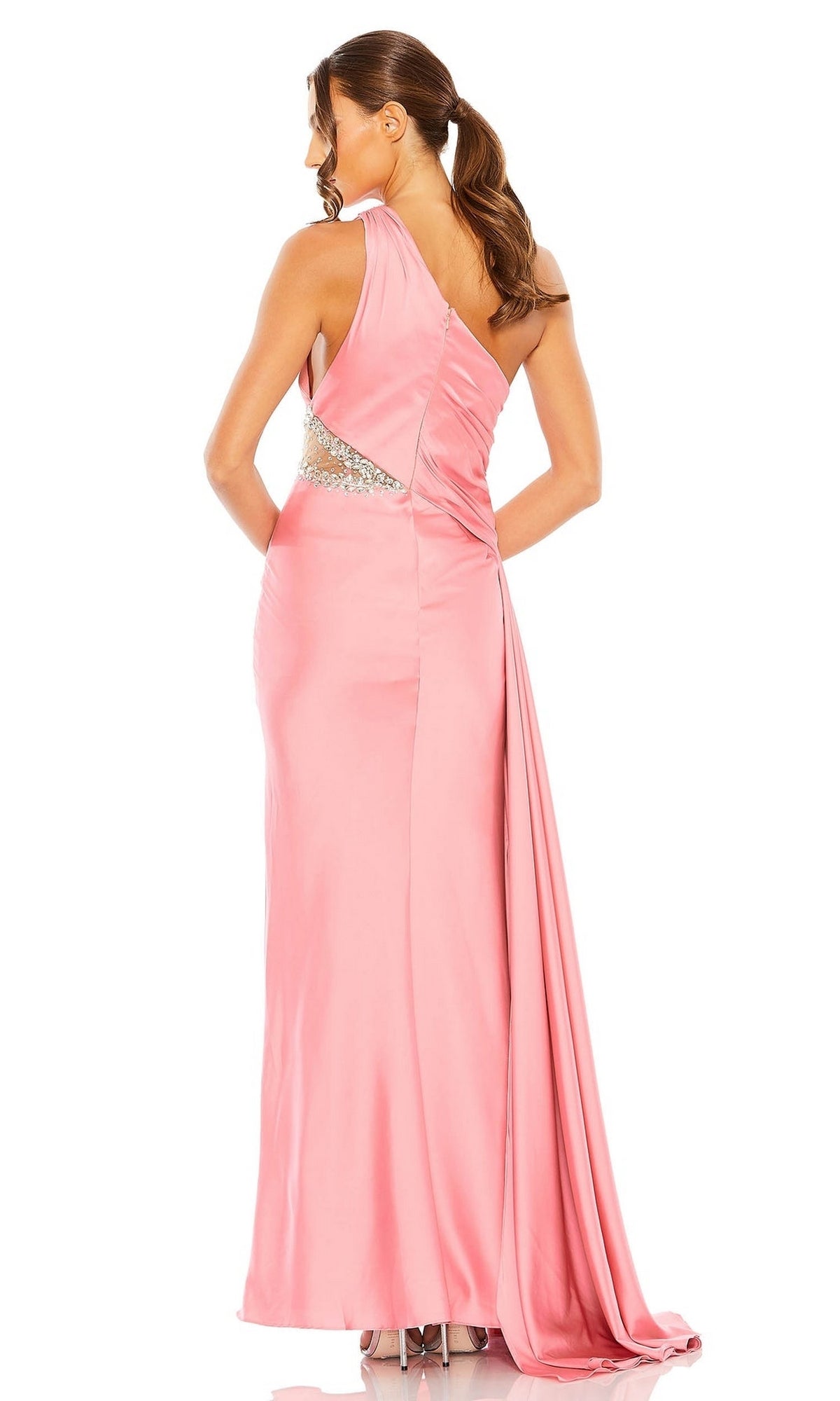 A woman stands with her back to the camera in a pink Mac Duggal 2210 Cut-Out One-Shoulder Formal Dress, showcasing a draped back and jeweled side cutout.