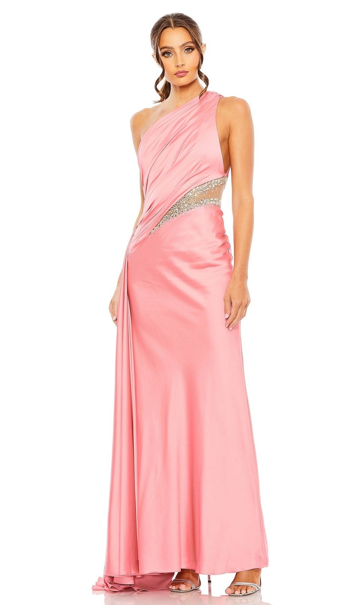 A woman poses against a white background in the Mac Duggal 2210 Cut-Out One-Shoulder Formal Dress, a pink satin gown with a side cutout and silver embellishments.