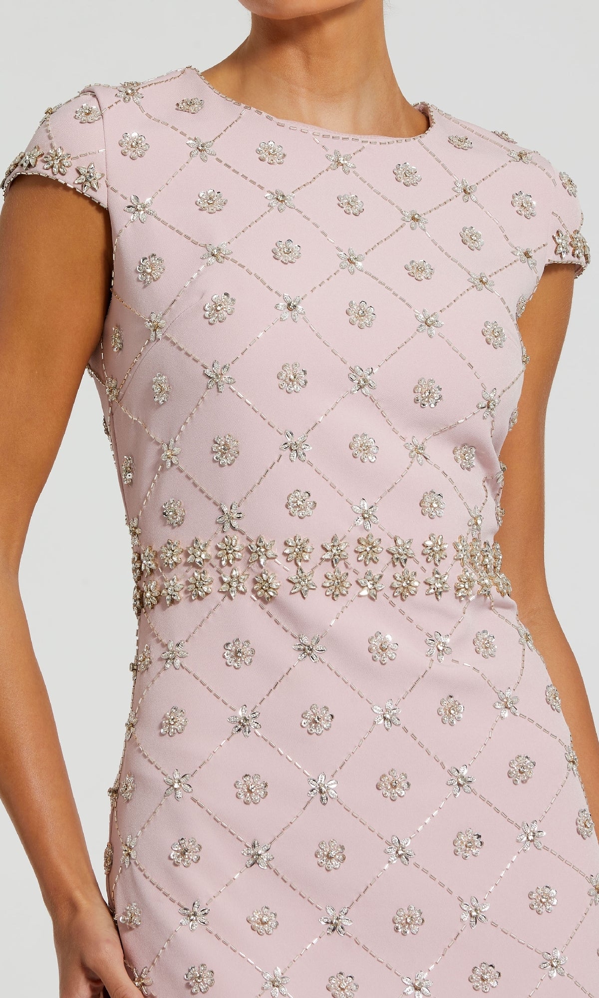A woman wears the Mac Duggal 2234, a mauve pink wedding guest dress with short sleeves, diamond pattern, and embellished floral beading—an elegant midi dress for any stylish event.