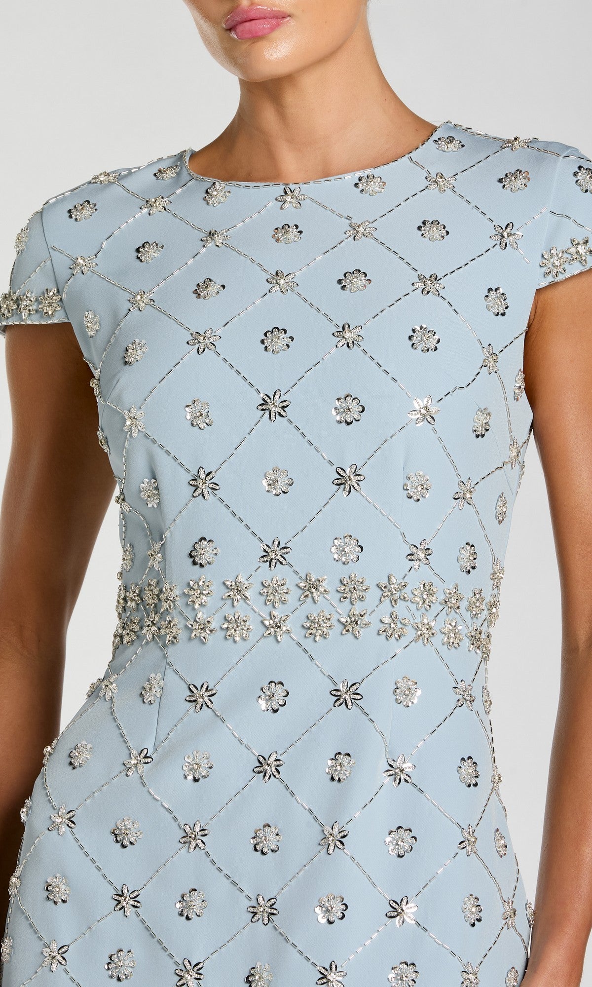 Wearing the Midi Beaded Wedding Guest Dress: Mac Duggal 2234—a light blue, short sleeve midi with silver diamond and floral embellishments—creates a stunning look inspired by signature Mac Duggal cocktail dress designs.