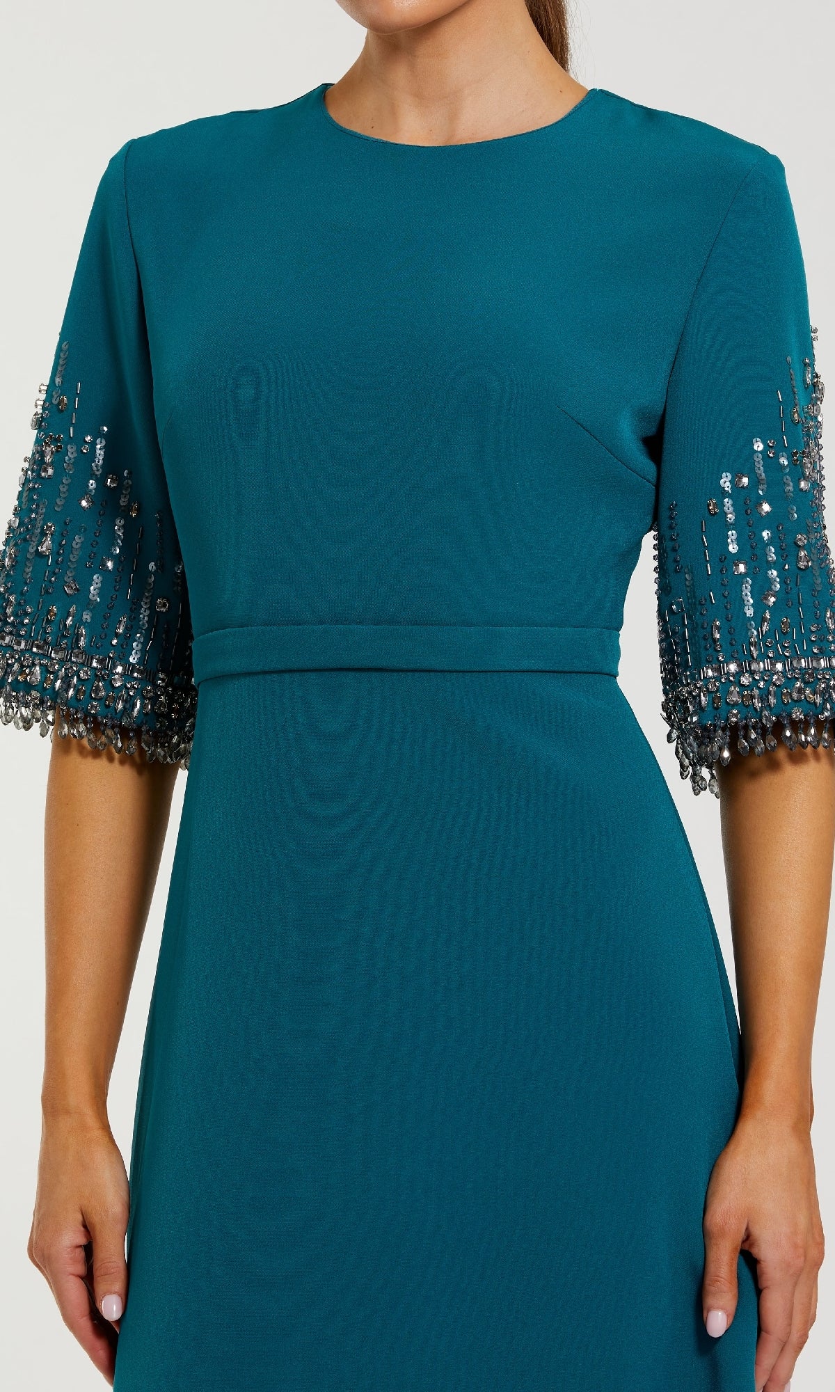 A woman wears the Short Sleeve Sleek Formal Dress: Mac Duggal 2270 in teal, featuring embellished short sleeves with bead and sequin details; her head is not visible.