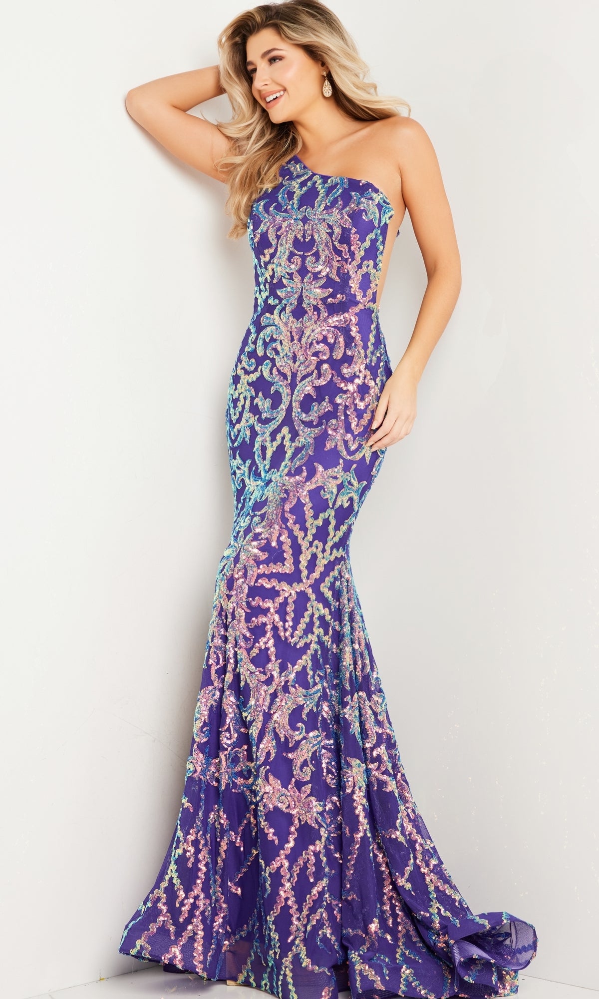 A woman poses against a white wall wearing the Jovani One-Shoulder Red Sequin Prom Dress 22845.