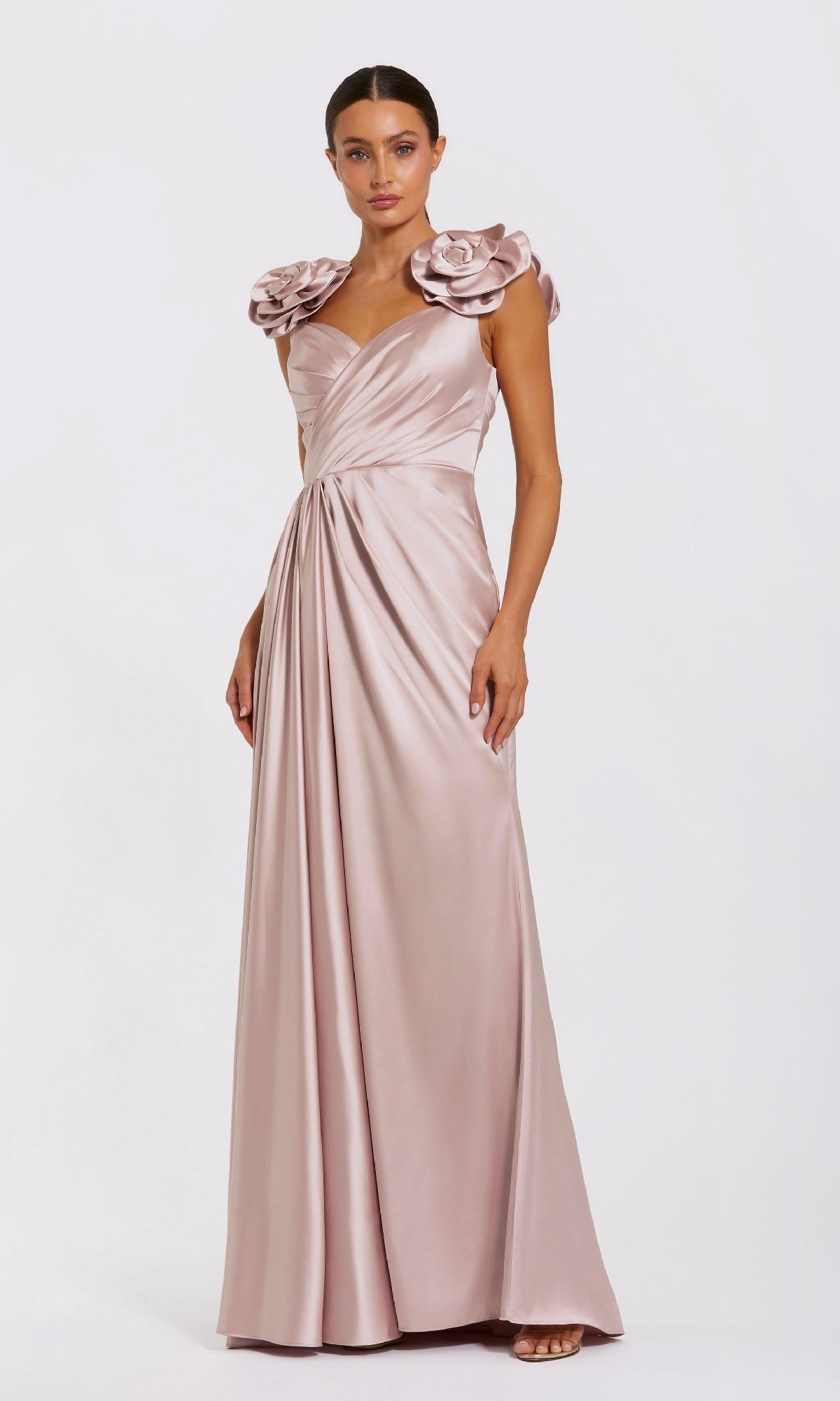 Model wearing the Mac Duggal 2299 rose pink long satin formal dress, featuring a ruched bodice and large ruffled shoulders, posed against a plain white background.