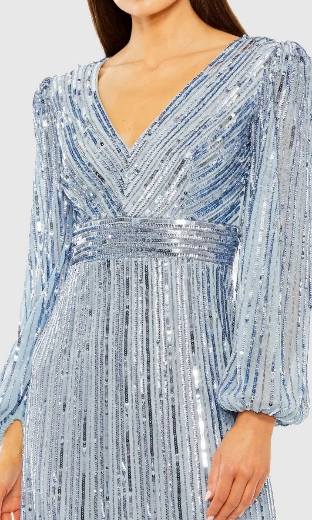 Wearing the Mac Duggal 23006 Midi Semi-Formal Dress—a light blue, midi-length sequin dress with vertical silver stripes and a flattering V-neckline.