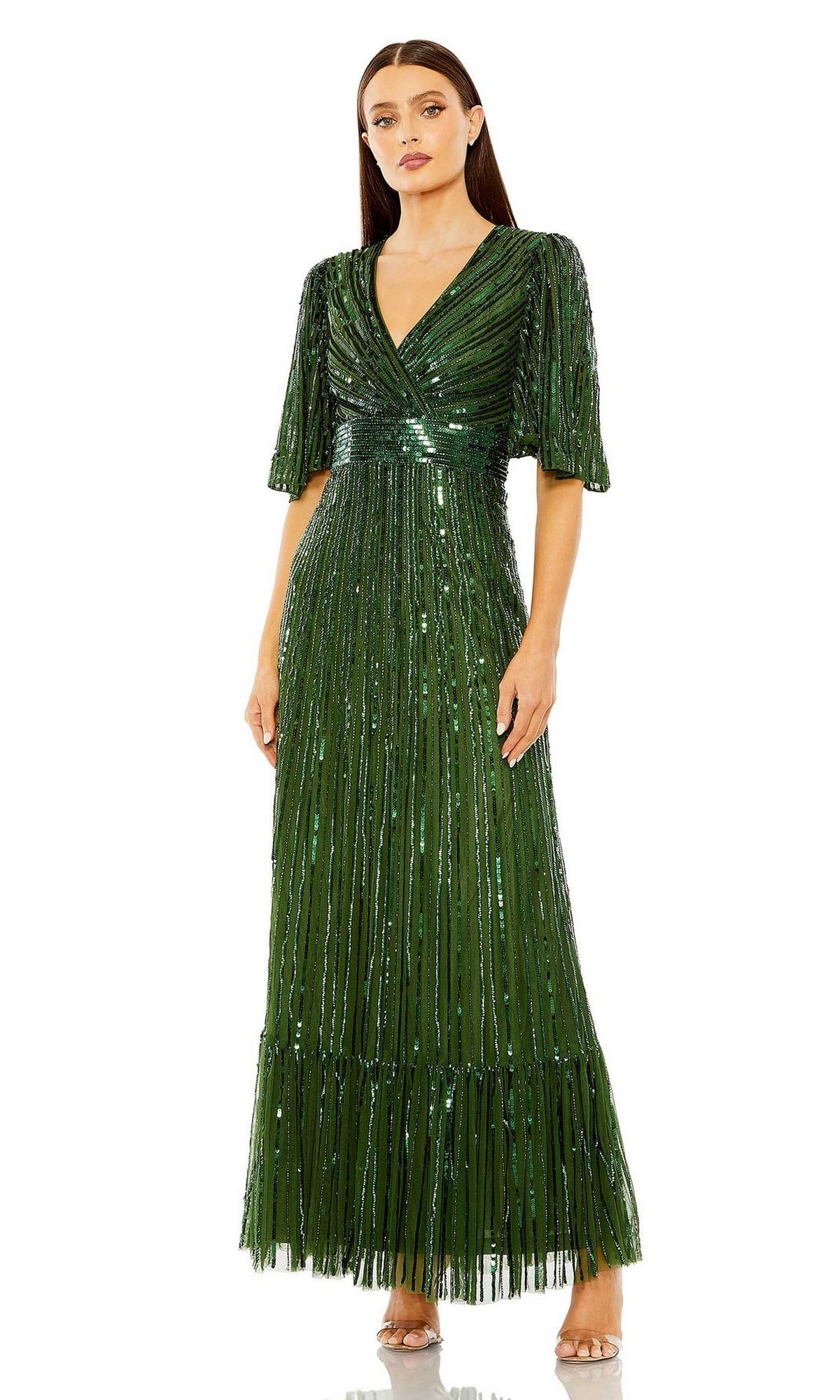 Woman wearing the Long Formal Dress 23010 by Mac Duggal—an emerald green formal gown with short sleeves, sequins, and a V-neckline—standing against a plain white background.