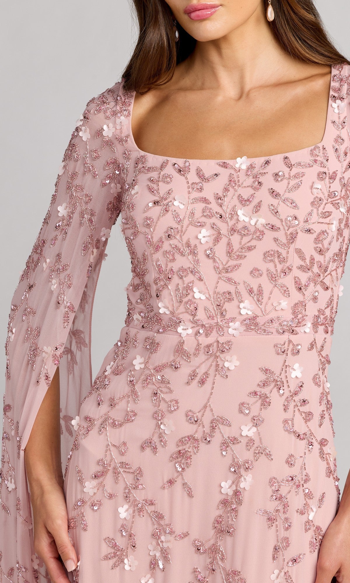 A woman wears the Mac Duggal 23068 Long Formal Dress in light pink with floral embroidery and sheer sleeves. Only her upper body is visible.