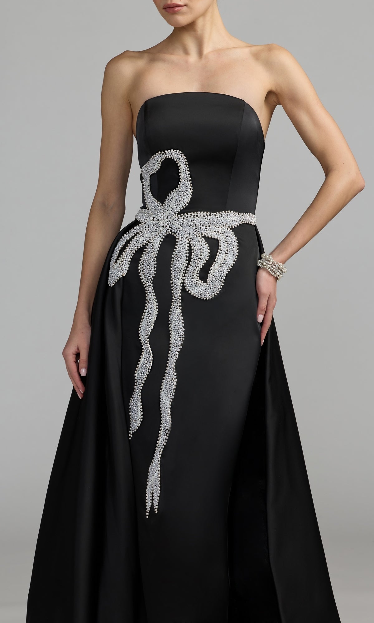Woman in a Mac Duggal strapless long blue formal dress (style 2317), standing against a plain gray background.