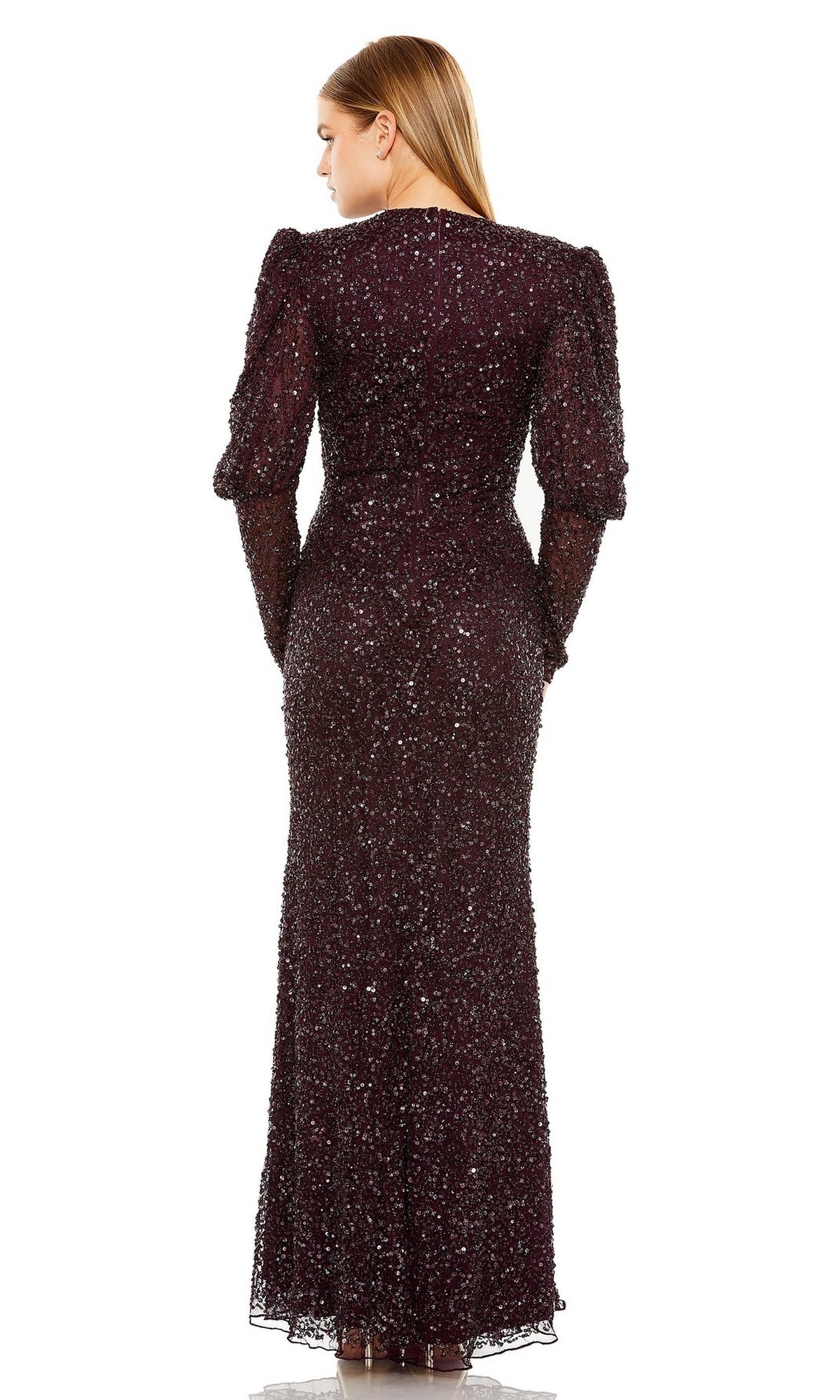 A woman faces away, wearing the Mac Duggal Long Formal Dress 24000—a floor-length, long-sleeved sequin gown with a fitted silhouette and subtly puffed shoulders.